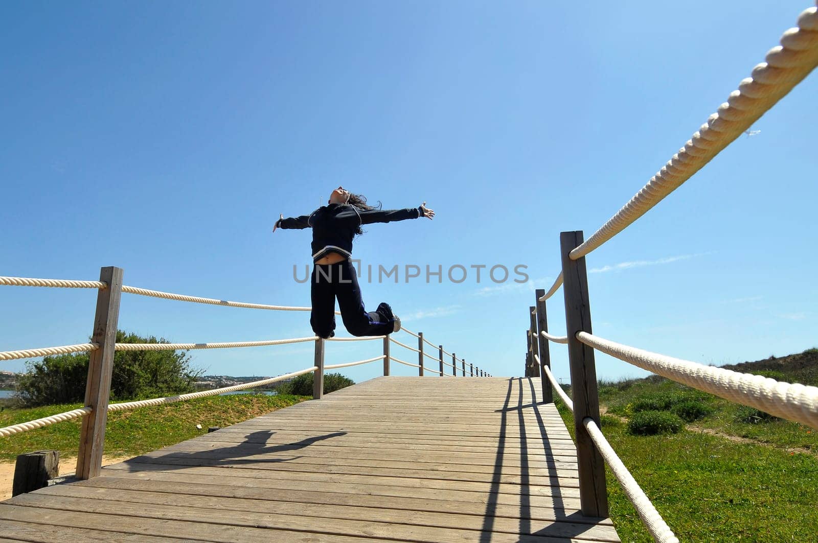 Woman jumping high outdoors