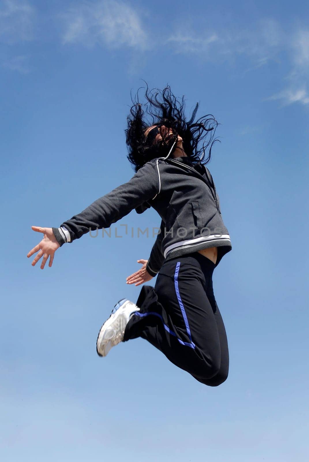 Woman jumping high outdoors
