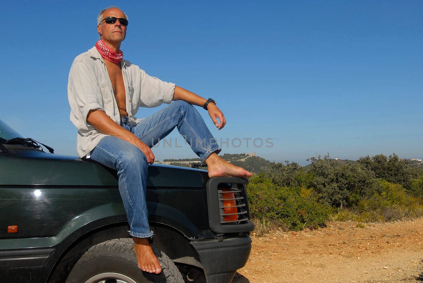 Mature man model posing in a 4x4 outdoors