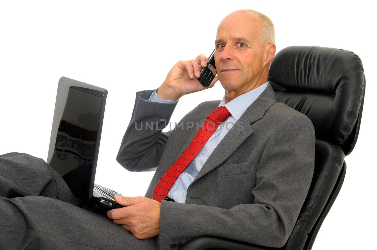 Mature man with cellphone and laptop isolated in white