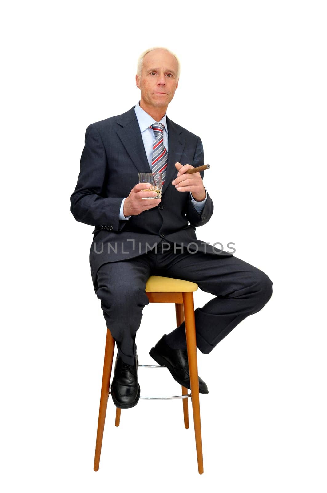 Businessman in a chair isolated in white