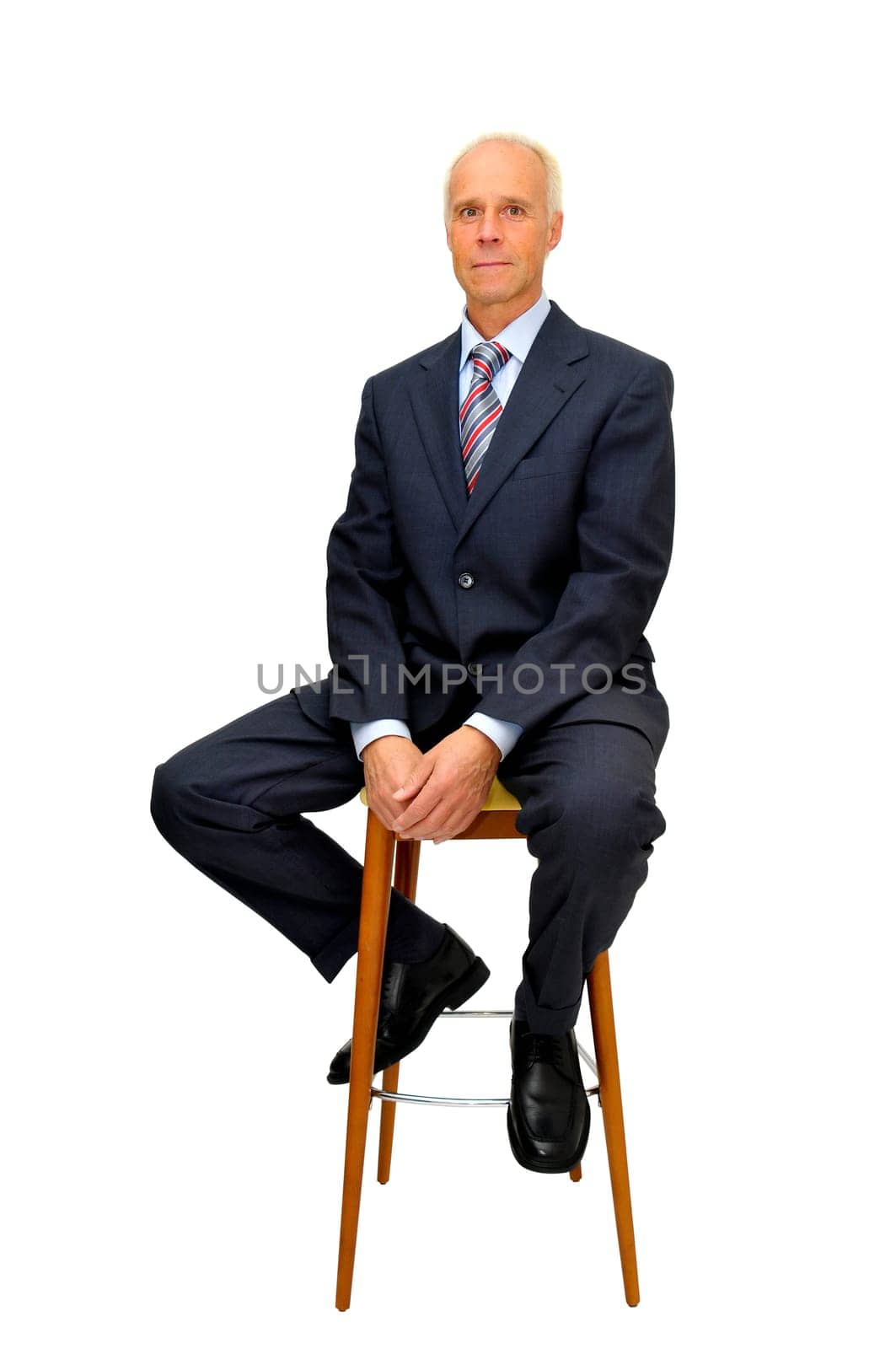 Mature businessman in a chair isolated in white