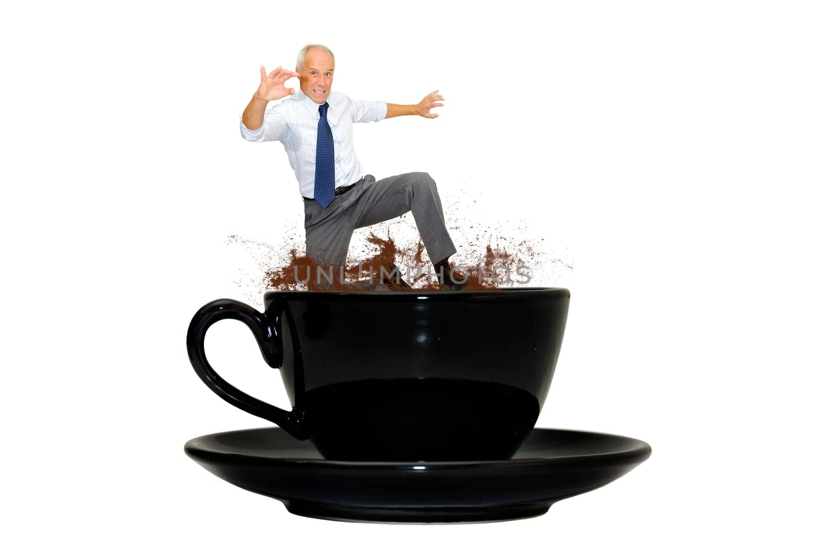 Mature businessman jumping from a coffee mug isolated in white