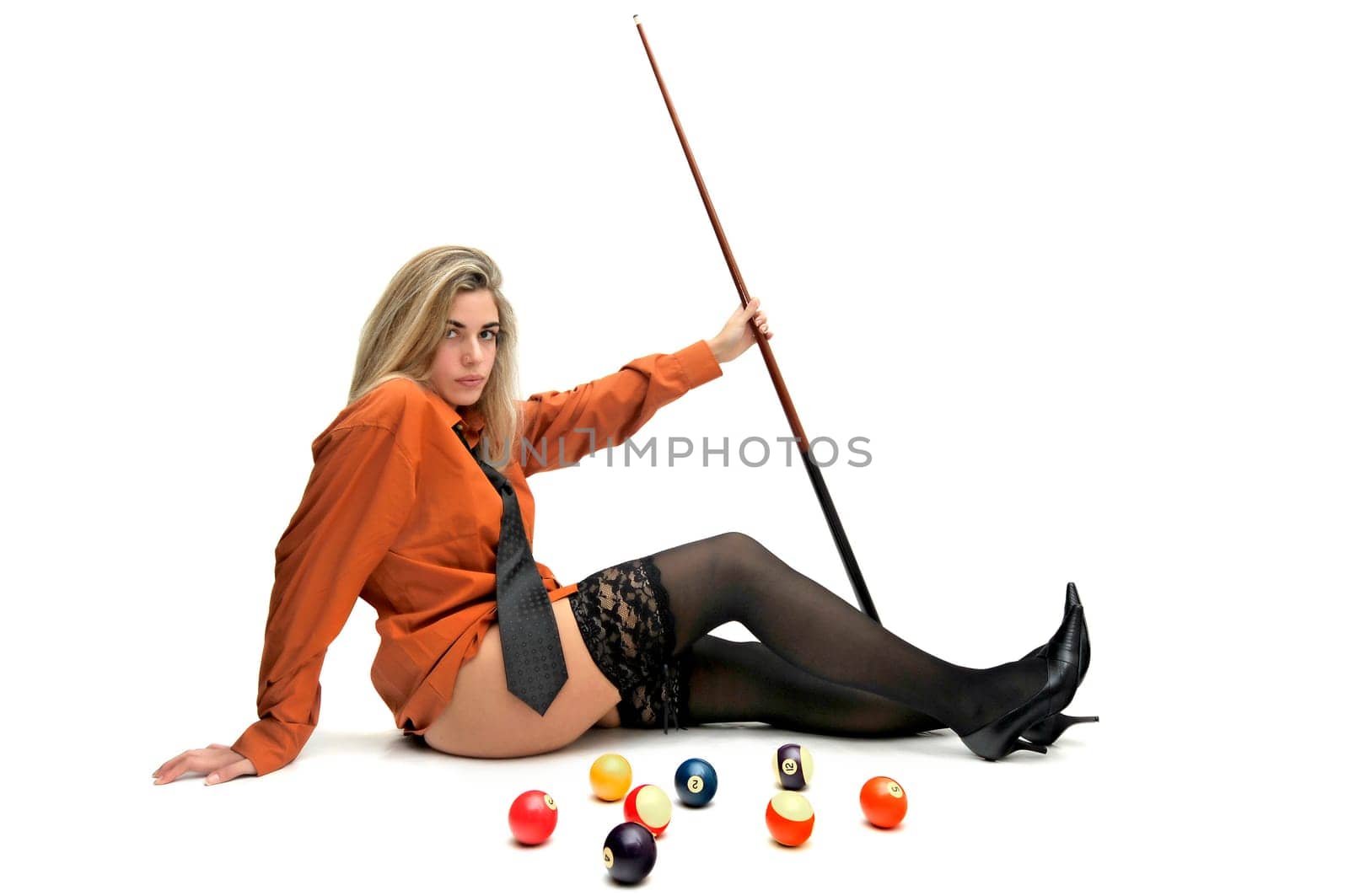 Sexy girl with man's shirt and tie holding a snooker cue