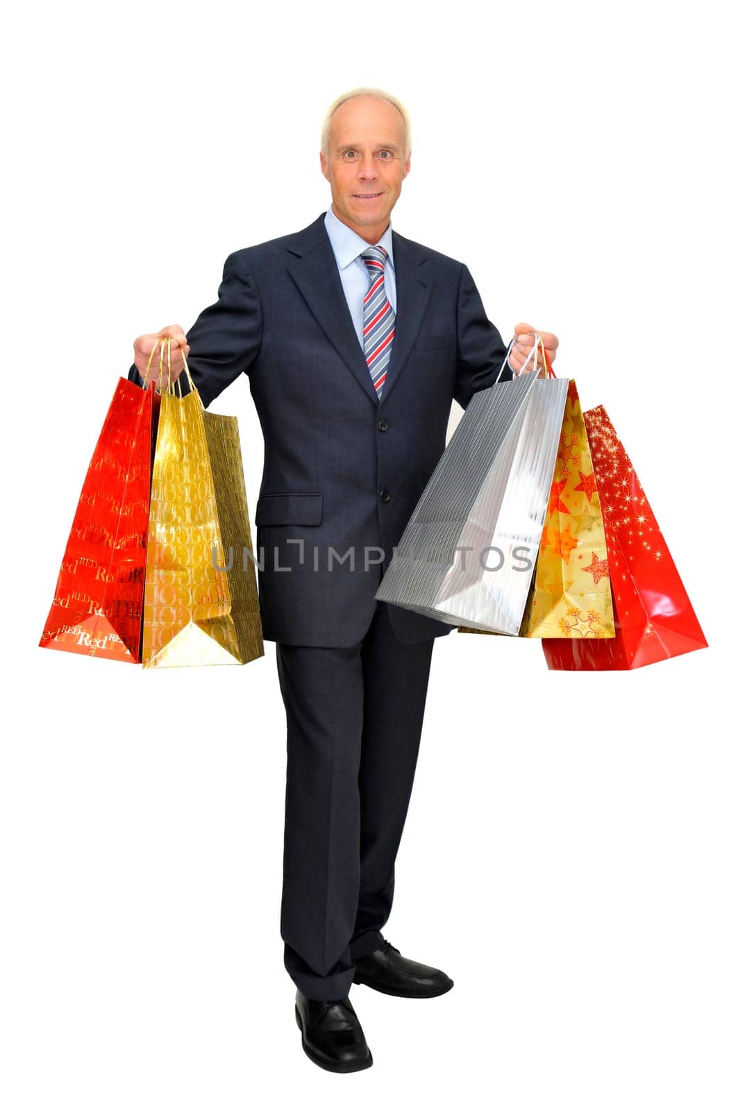 Mature businessman with lots of bags shopping isolated in white