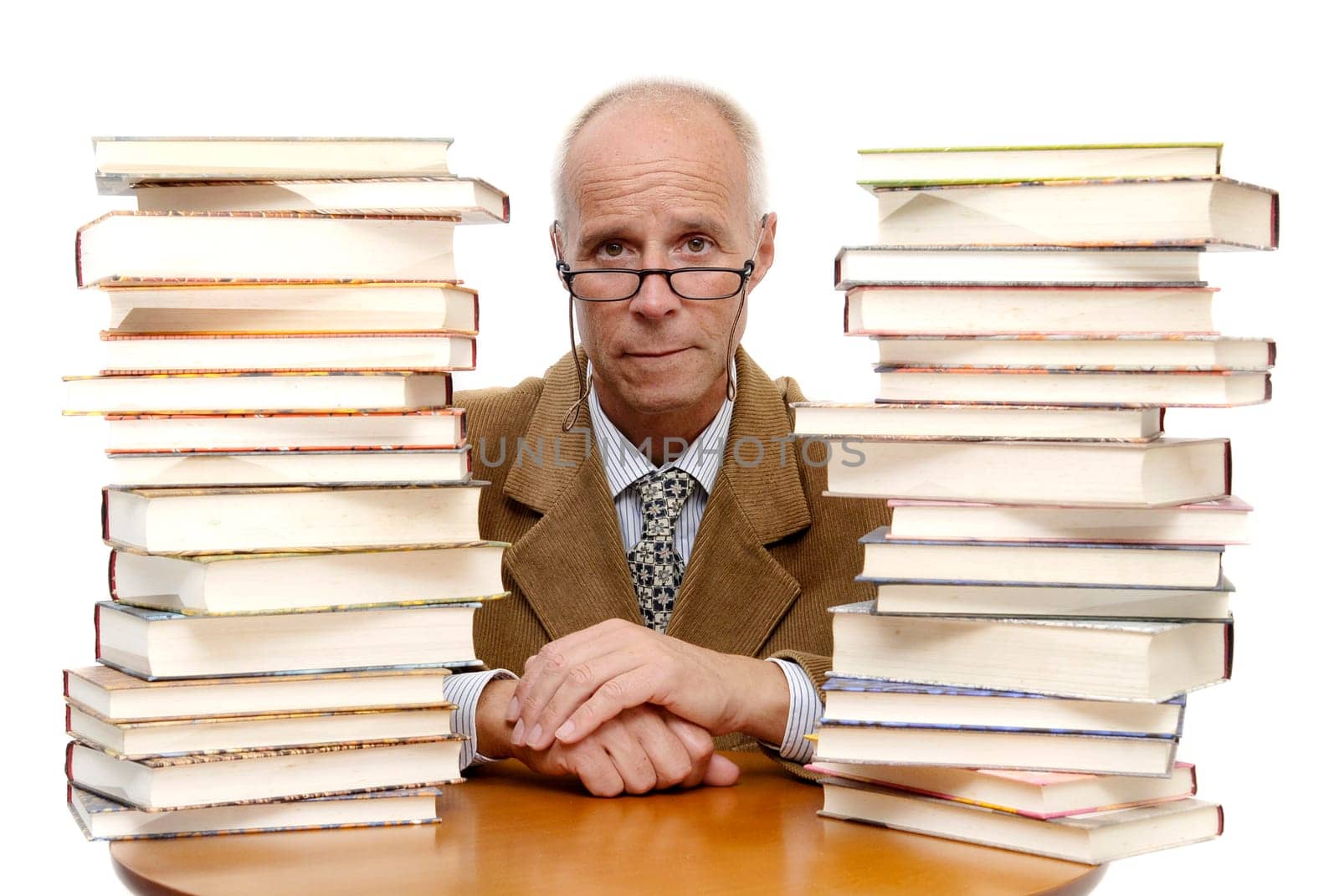 Mature man surounded by books against a white background