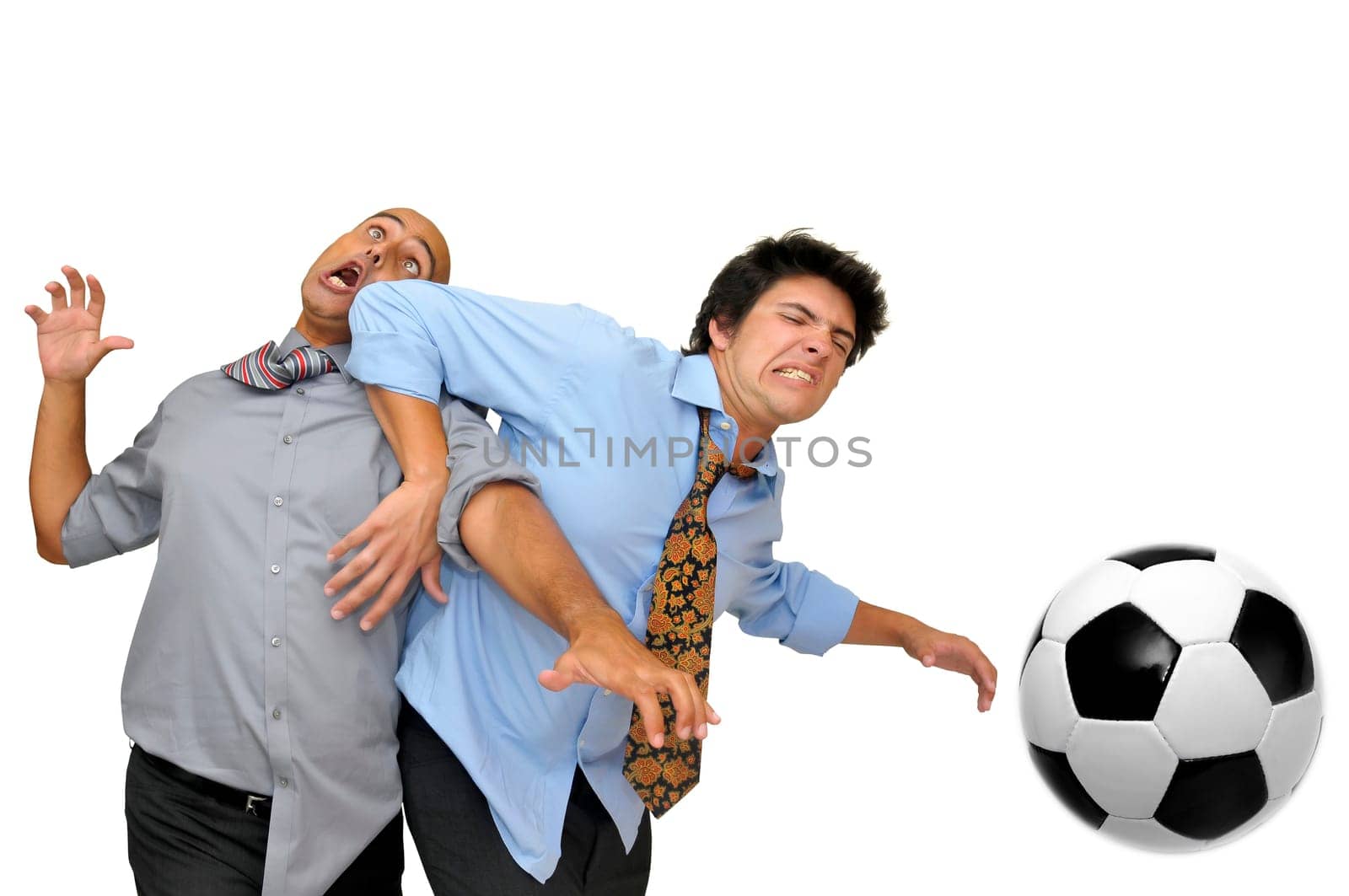 Two businessmen fighting for a soccer ball isolated in white