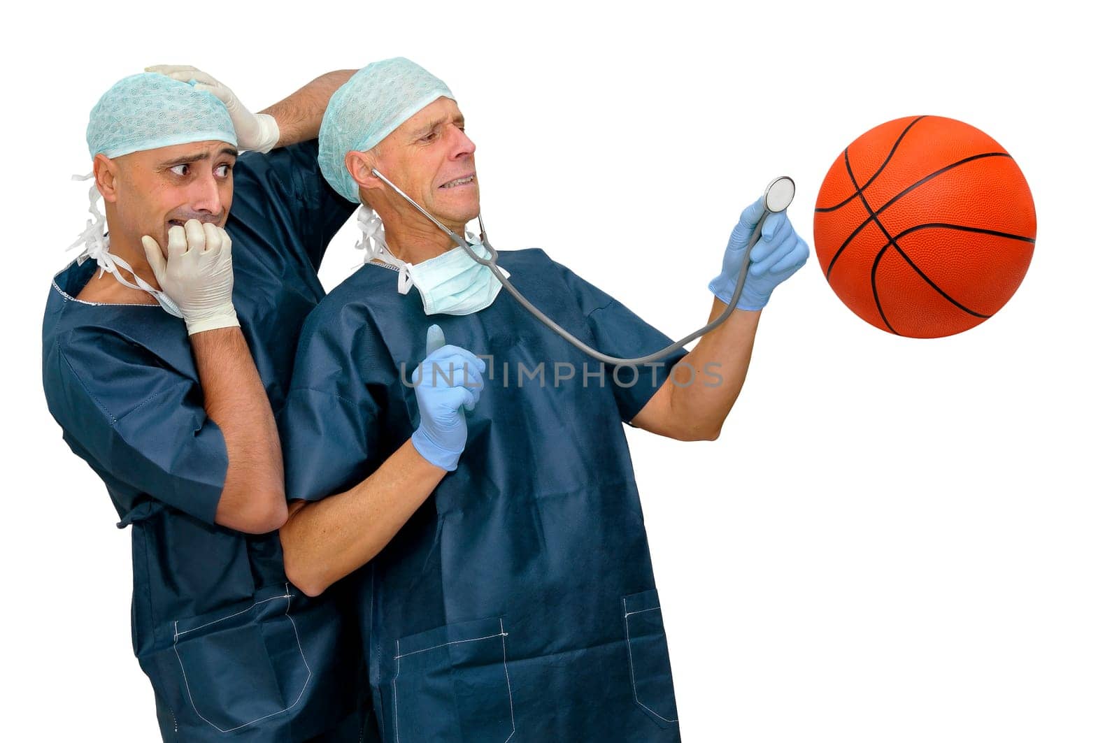 Doctors with scared faces inspecting a basket ball isolated in white