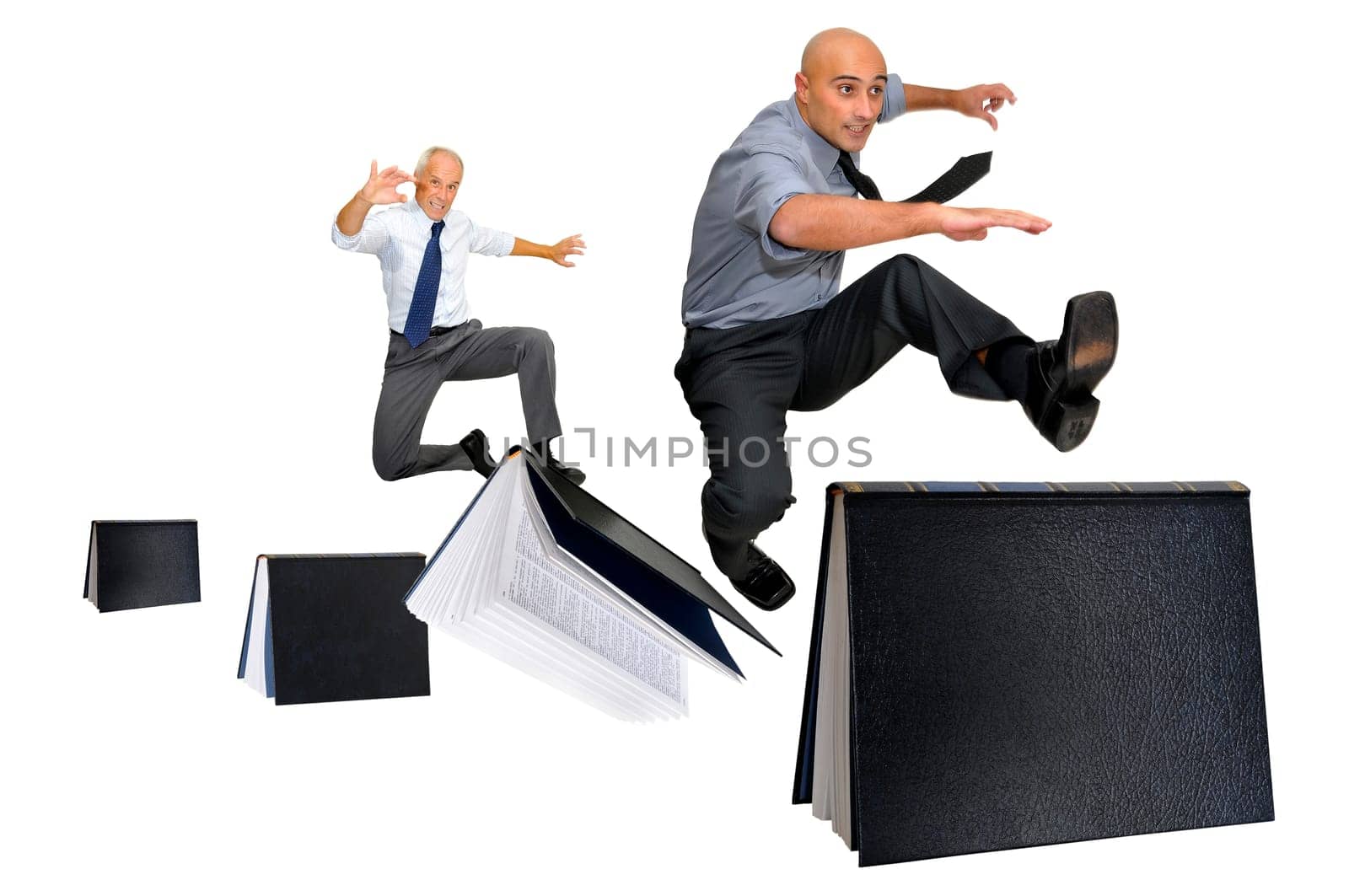 Businessmen jumping over books isolated in white