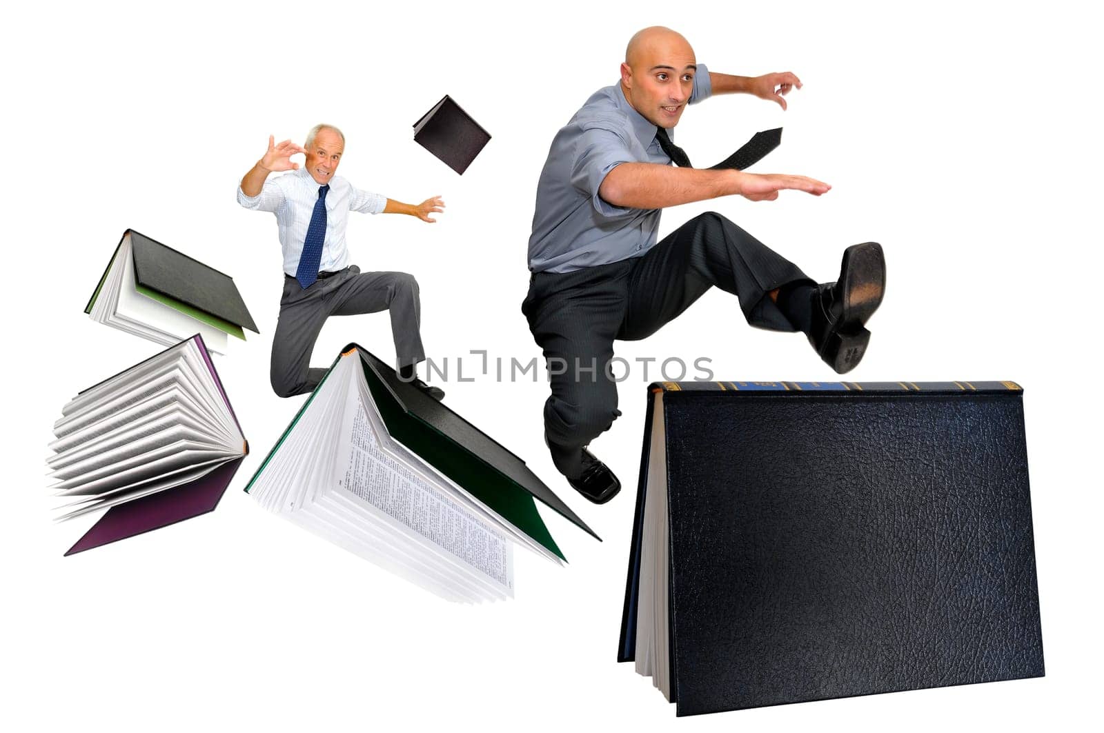 Businessmen jumping over books isolated in white