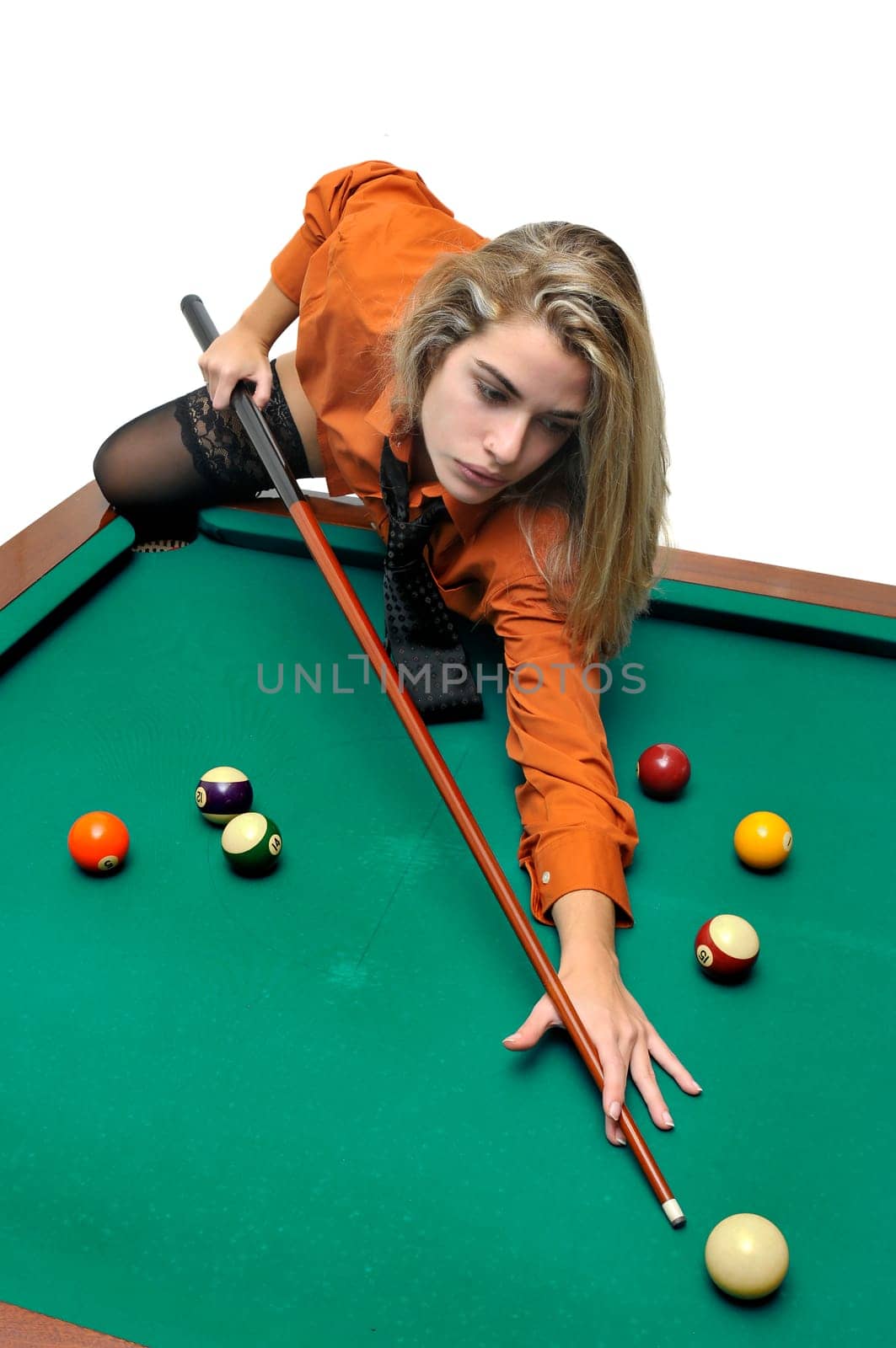 Sexy girl with man's shirt and tie playing snooker
