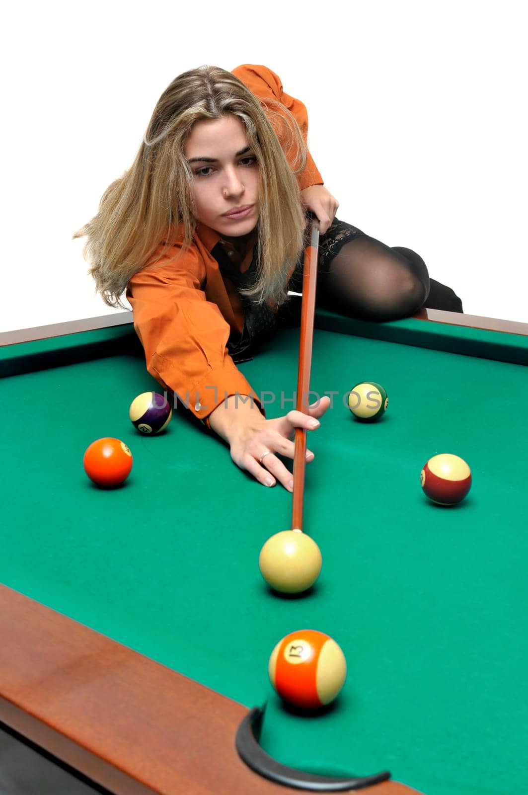 Sexy girl with man's shirt and tie playing snooker