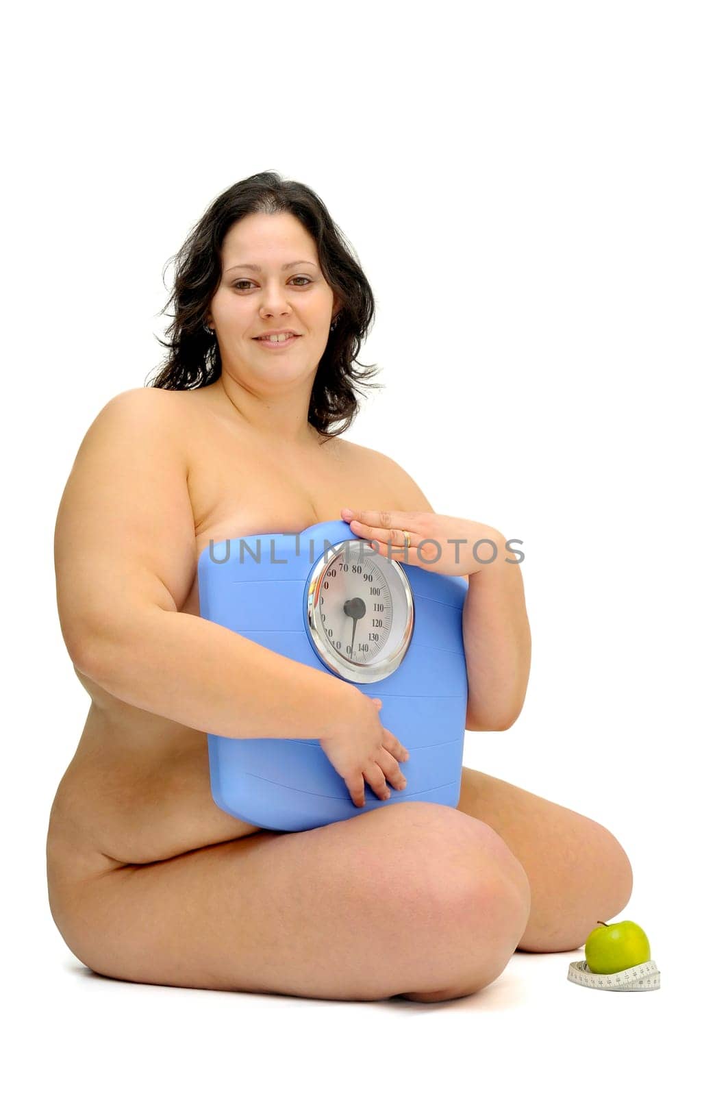 Beautiful nude large girl with weight scale isolated in white