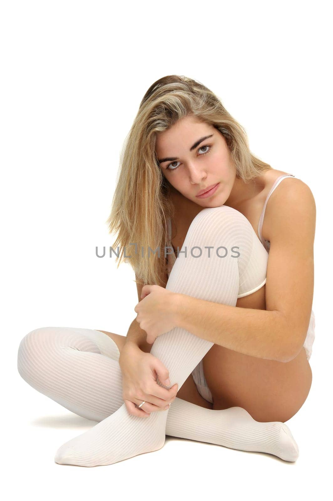 Sexy girl in white and pink lingerie posing isolated in white