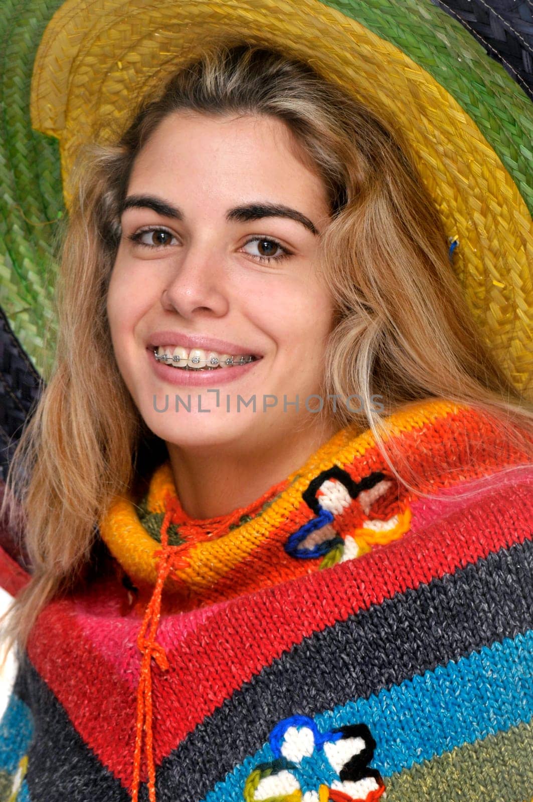 Sexy girl posing with a big sombrero hat isolated in white