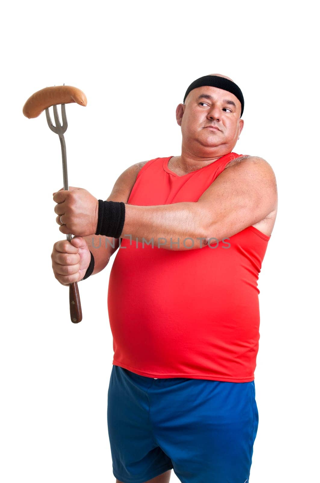 Large fitness man looking at a big sausage isolated in white