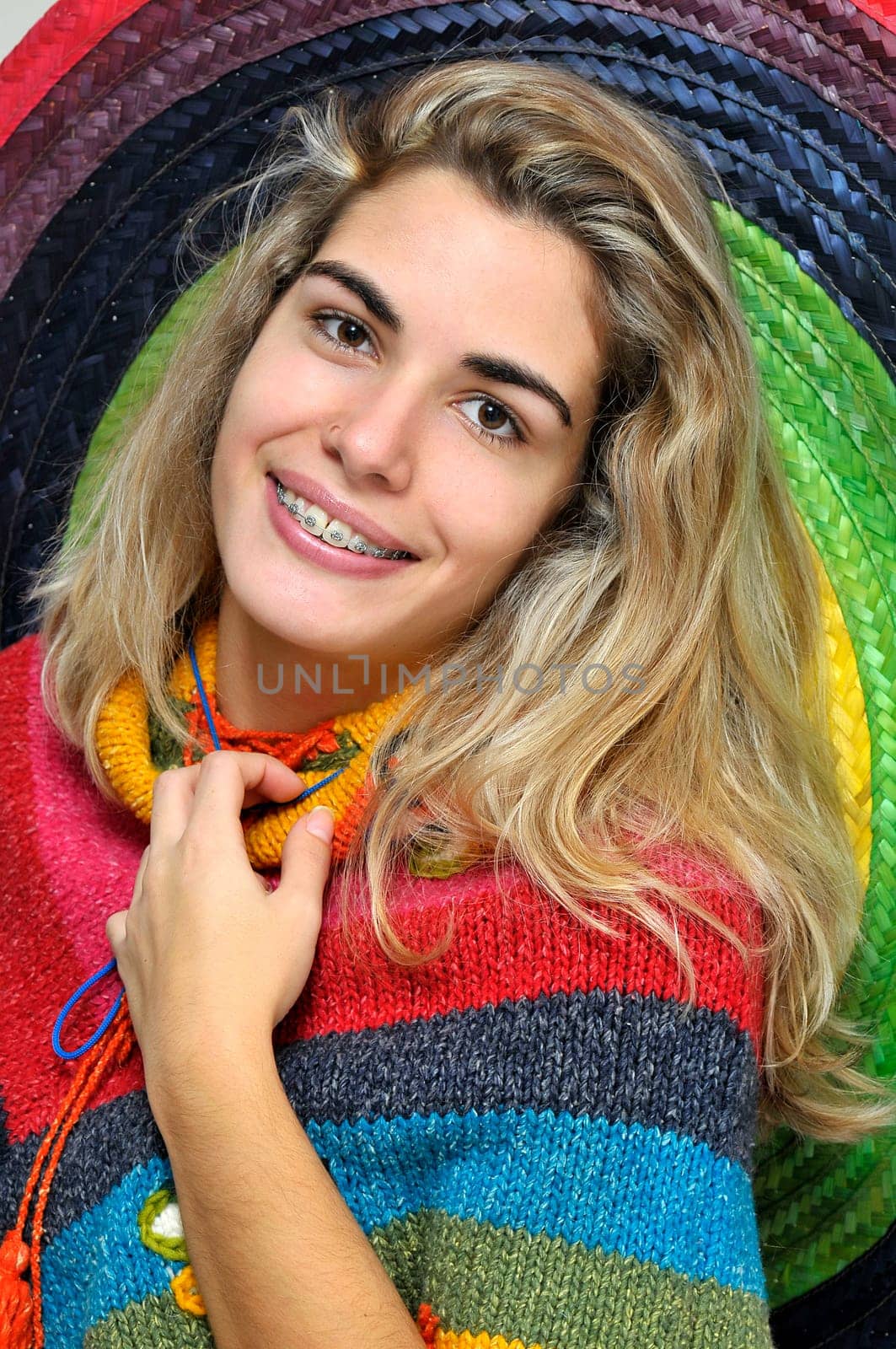 Sexy girl posing with a big sombrero hat isolated in white
