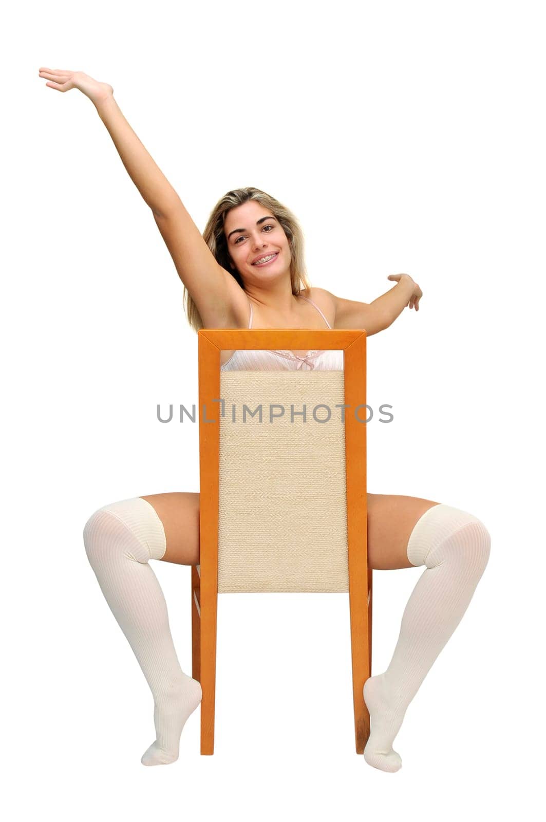 Sexy girl in white lingerie seated in a chair isolated in white