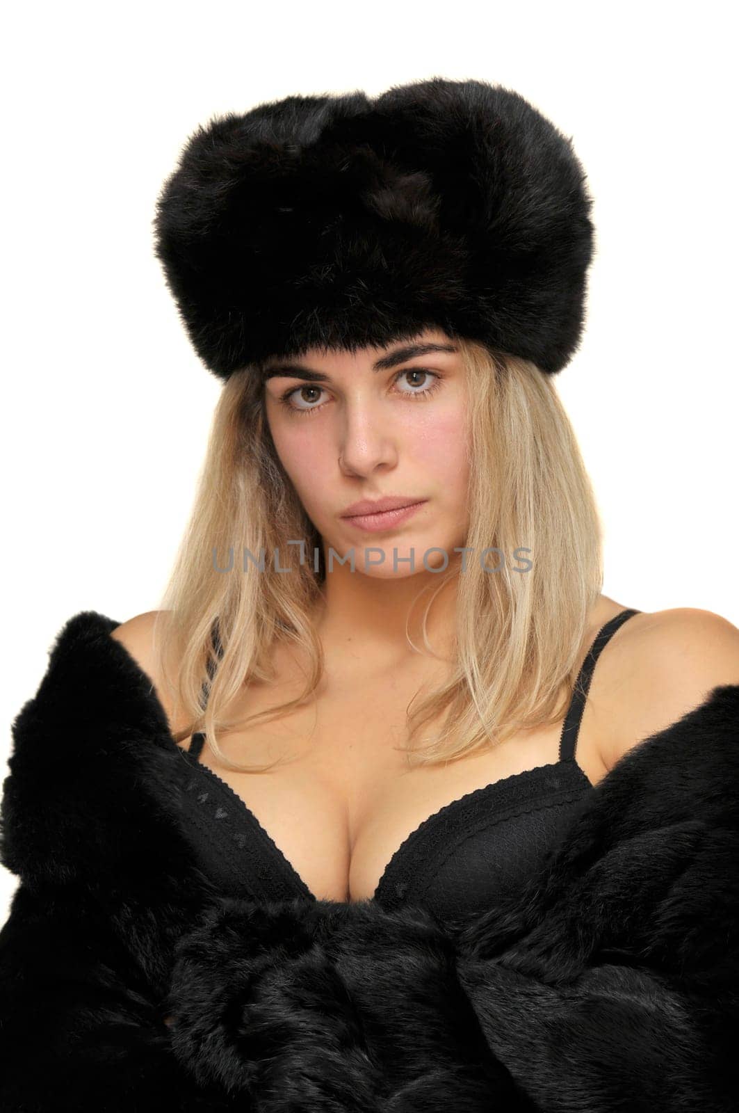 Sexy girl in furs and black lingerie isolated in white