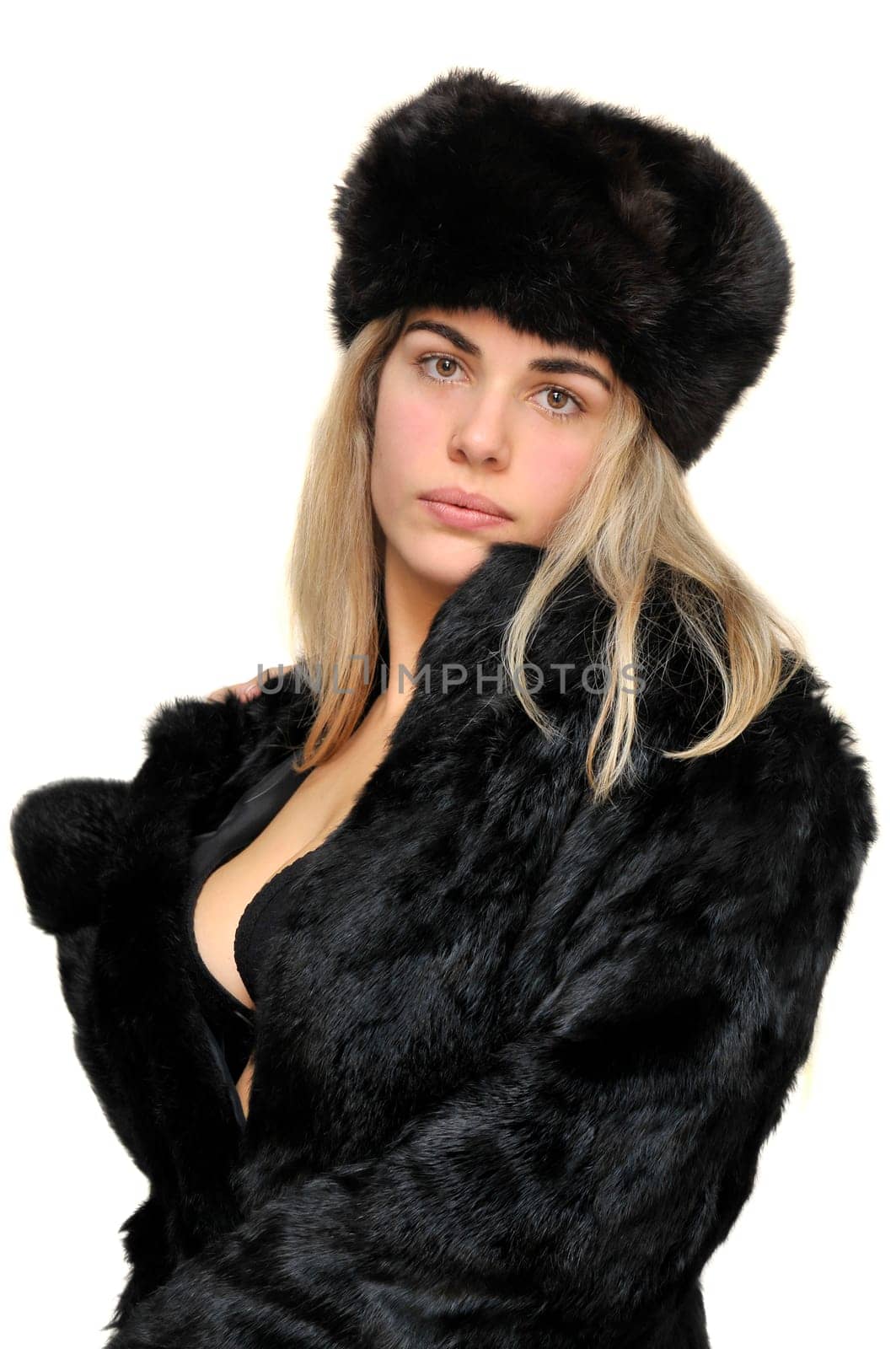 Sexy girl in furs and black lingerie isolated in white