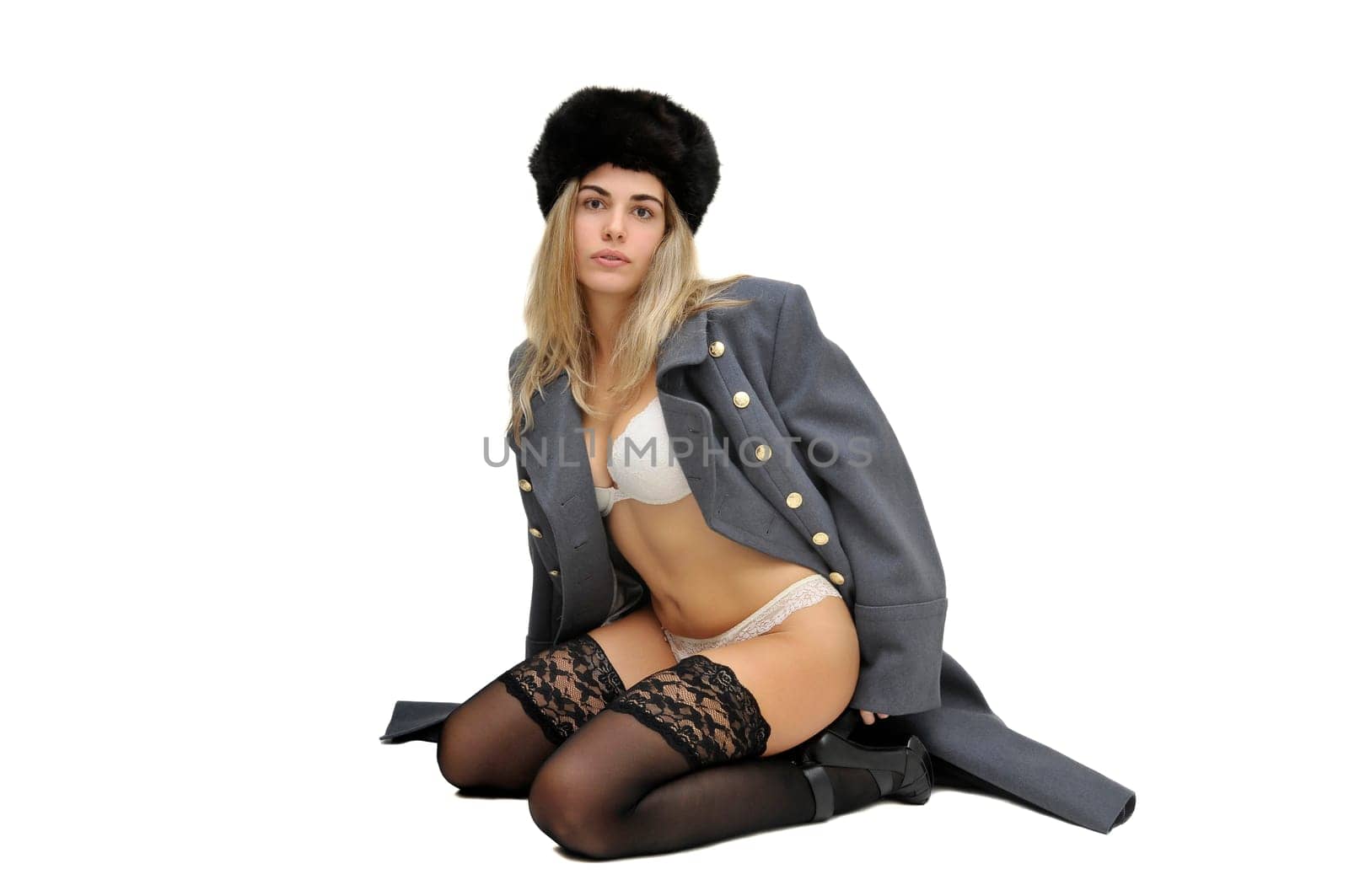 Sexy girl in russian army greatcoat and lingerie isolated in white