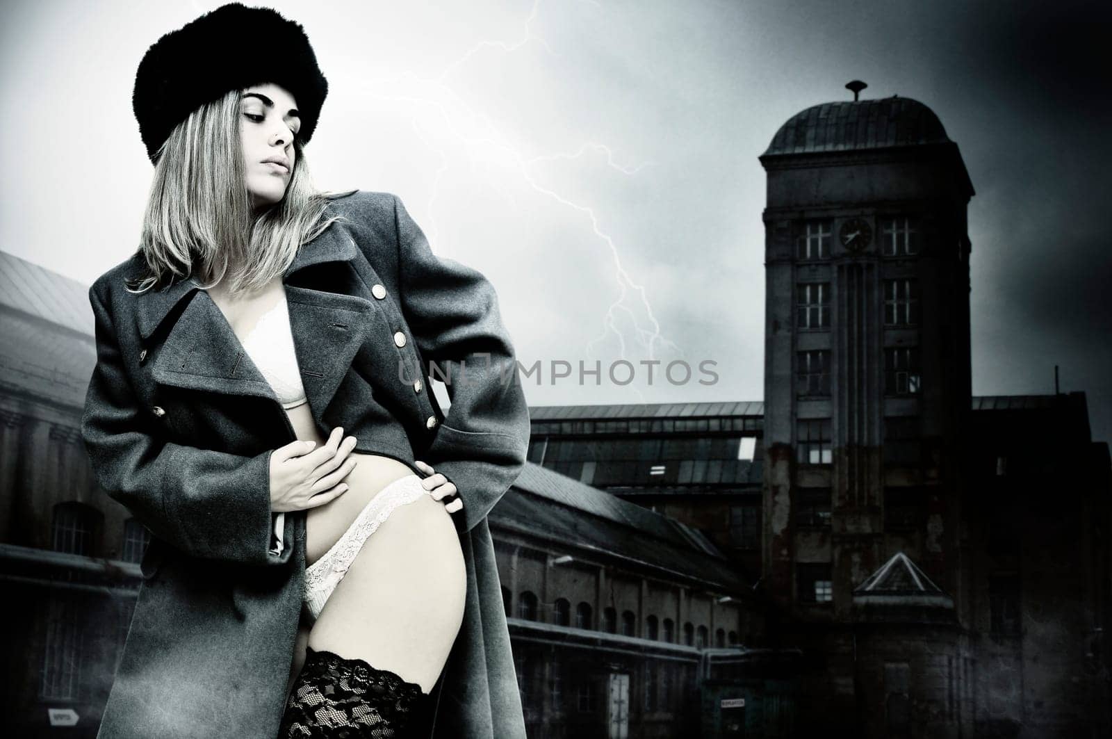 Sexy girl in russian army greatcoat and lingerie isolated in white