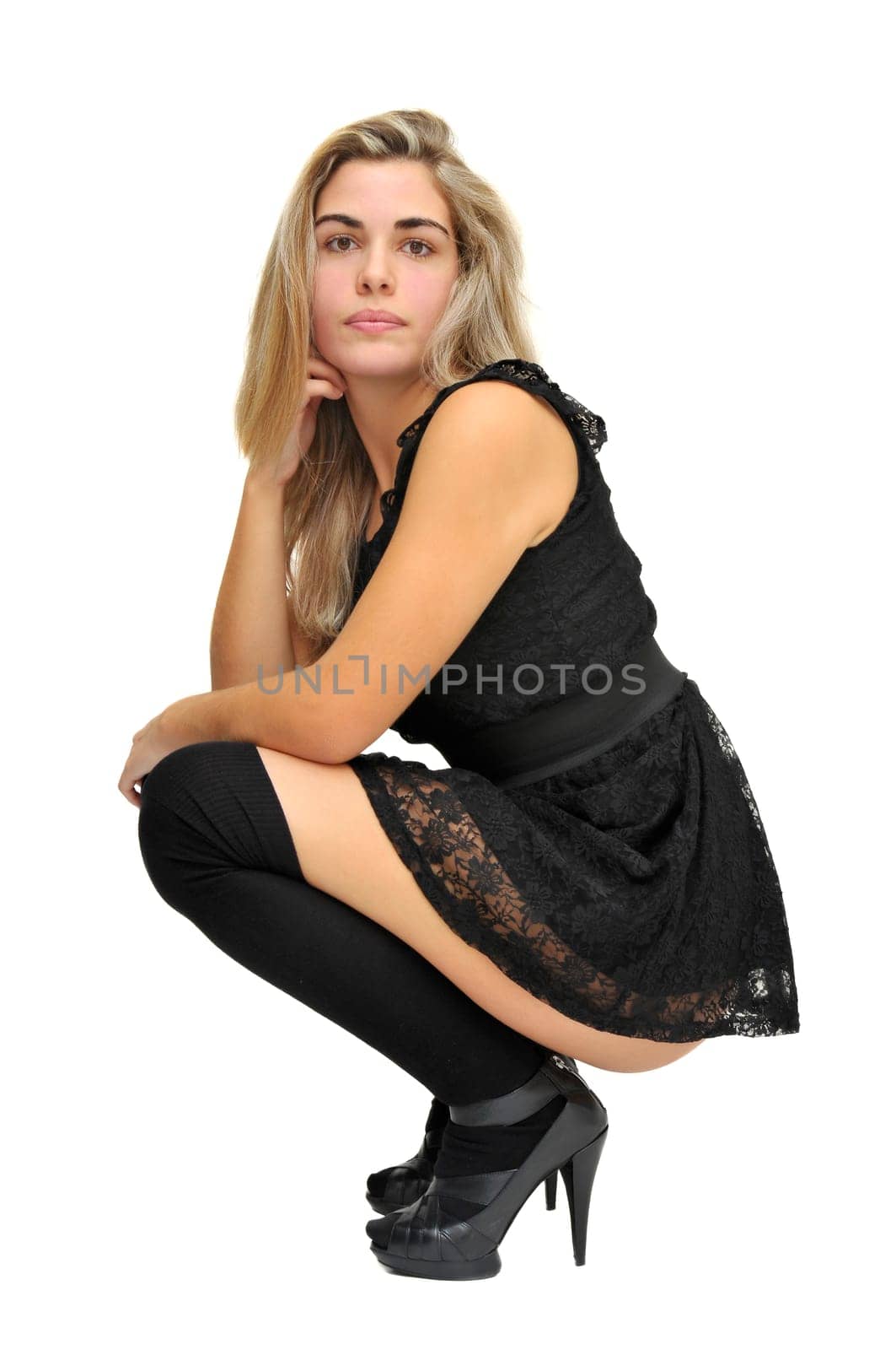 Sexy girl in a black dress isolated in white