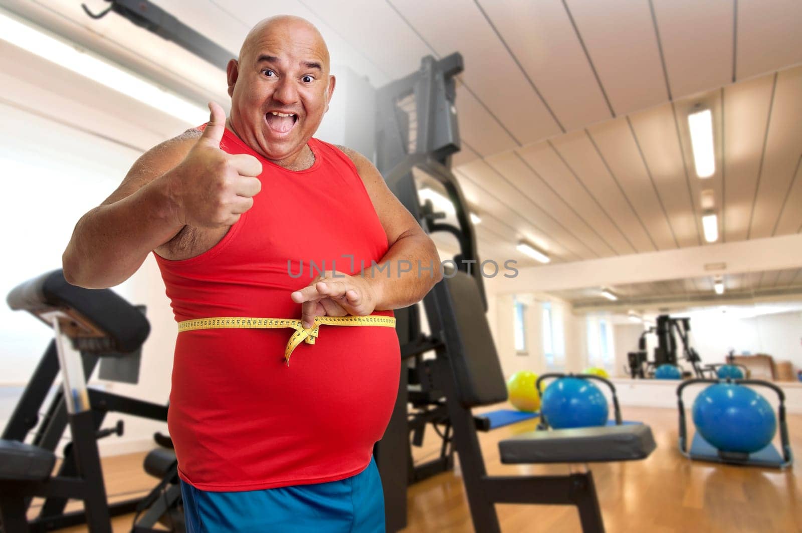 Large fitness man with measuring tape