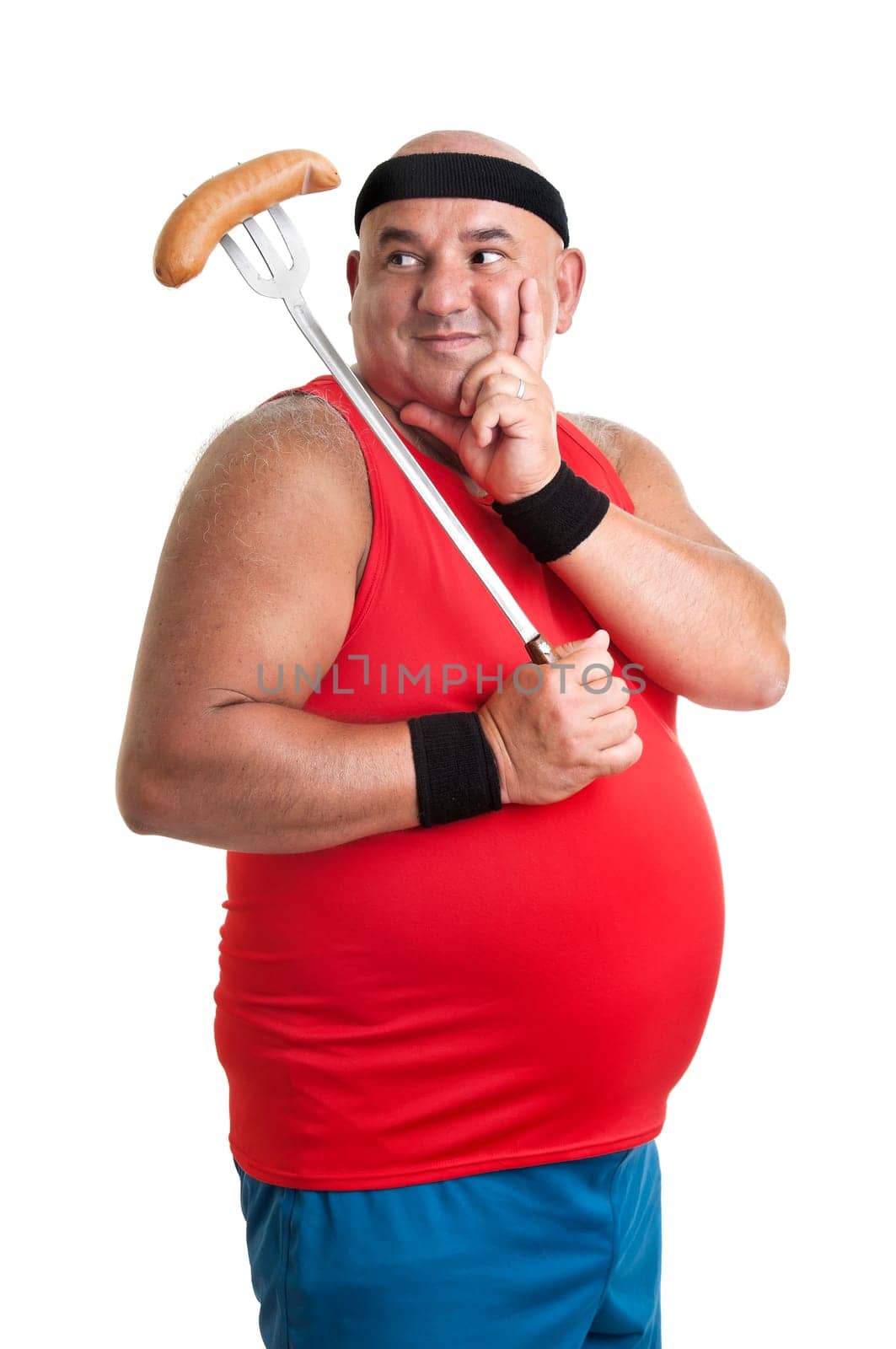 Large fitness man looking at a big sausage isolated in white