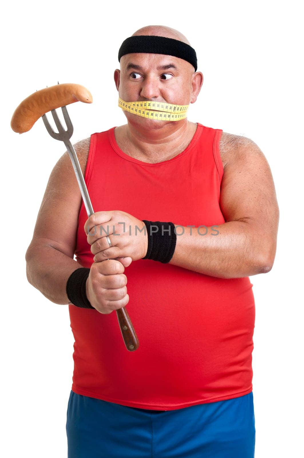 Large fitness man looking at a big sausage isolated in white