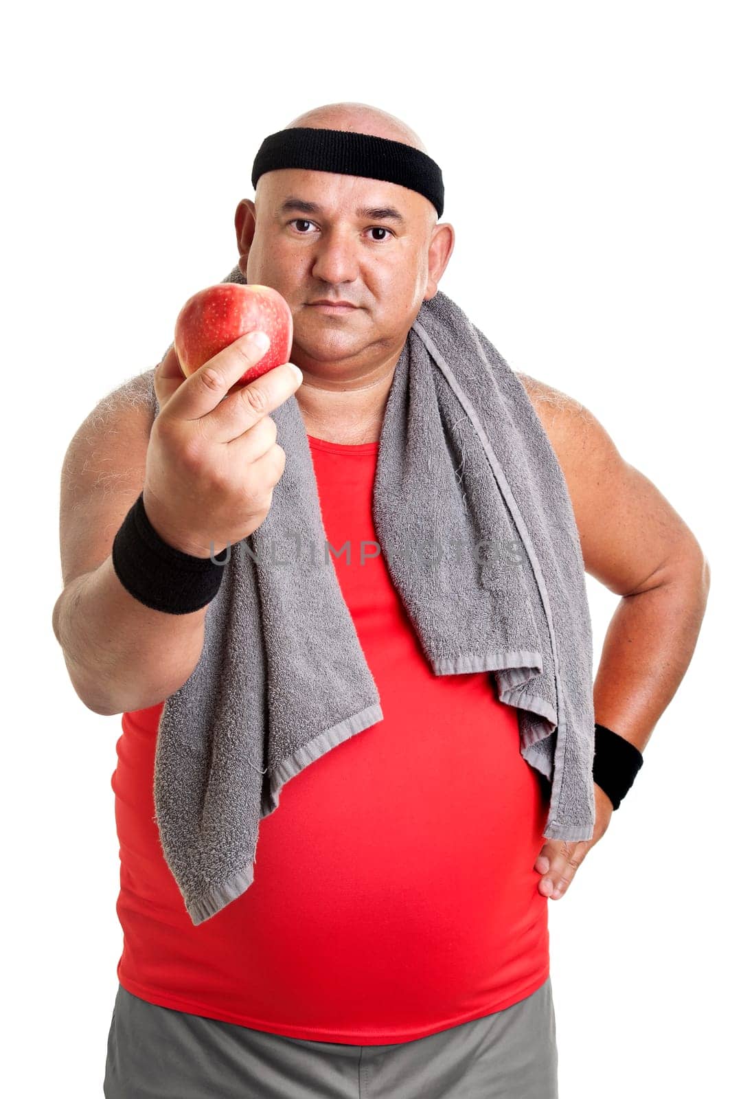 Large fitness man with an apple isolated in white