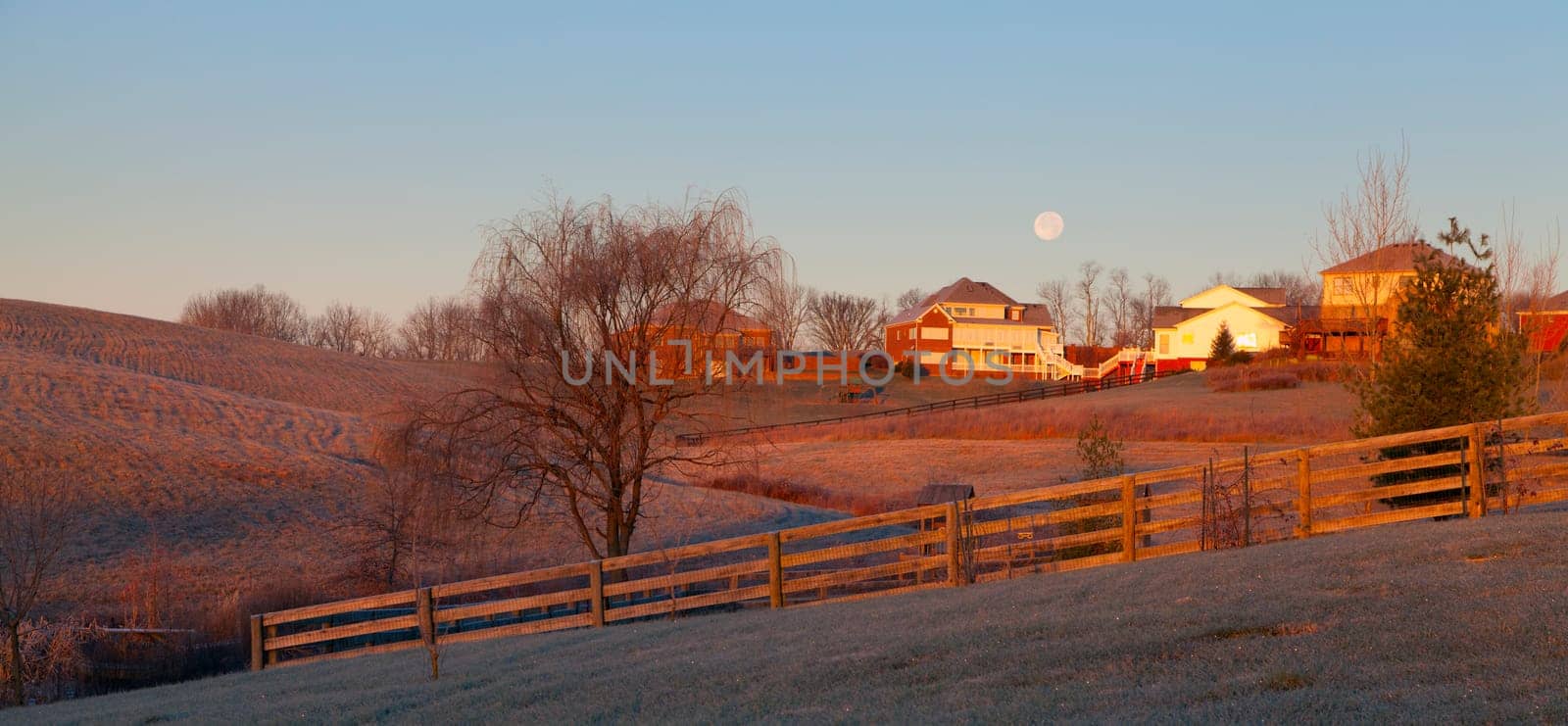 Moon setting over a suburban residential neighborhood