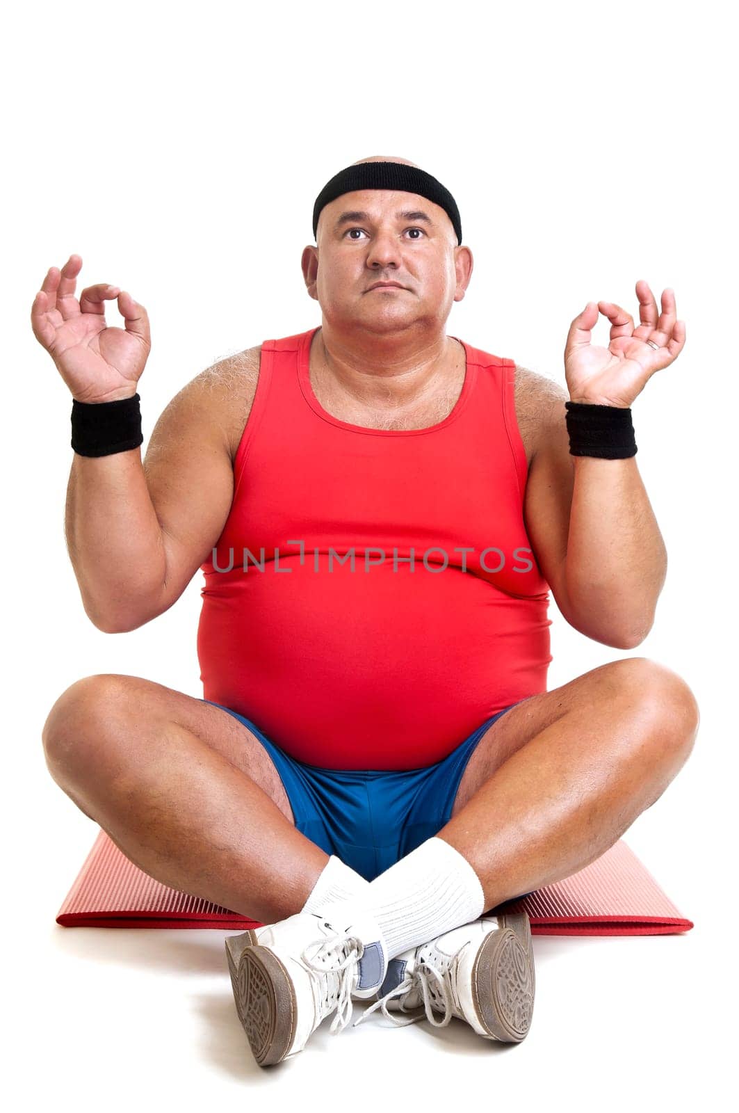 Large fitness man doing yoga exercices isolated in white