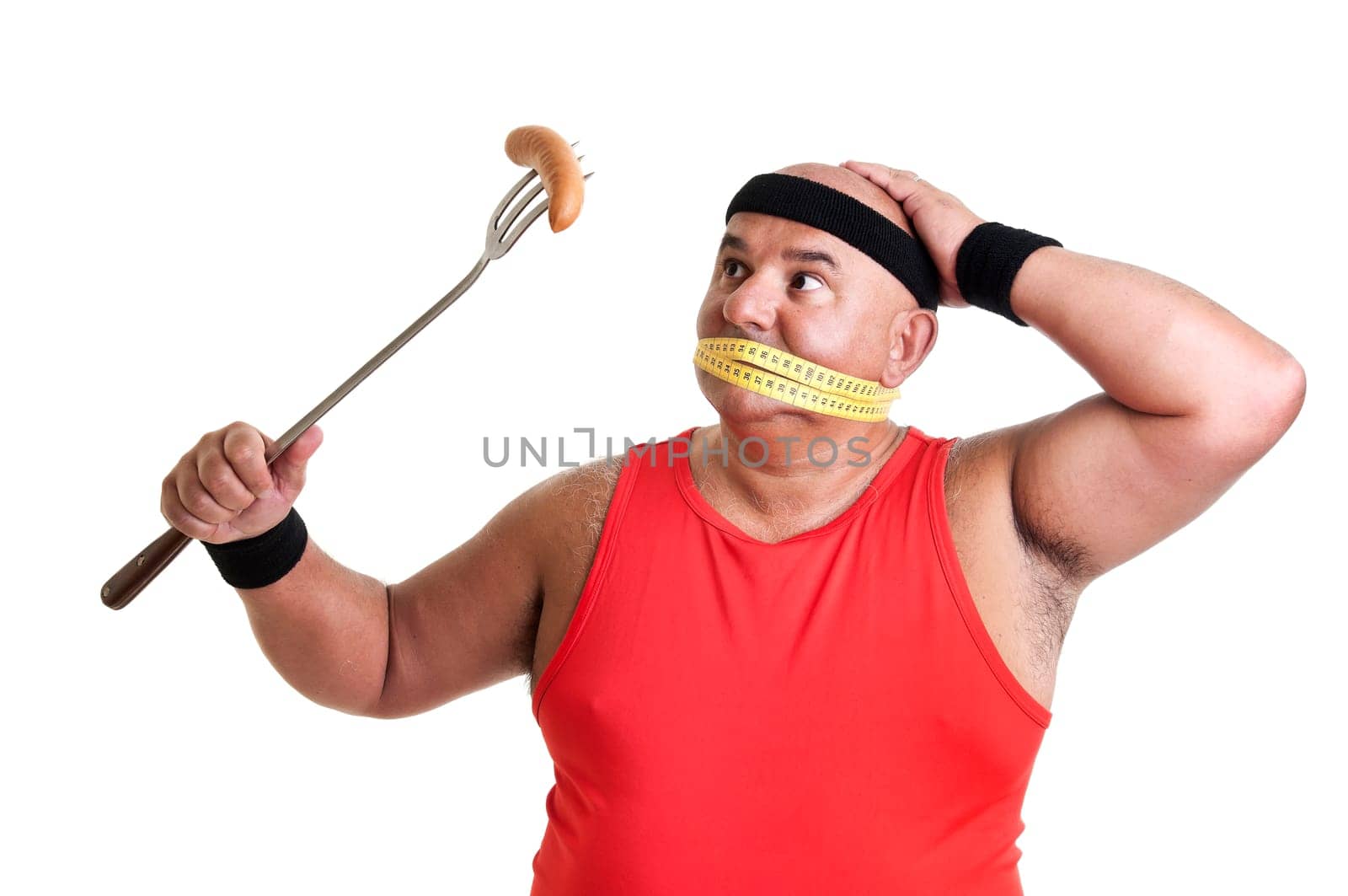 Large fitness man looking at a big sausage isolated in white