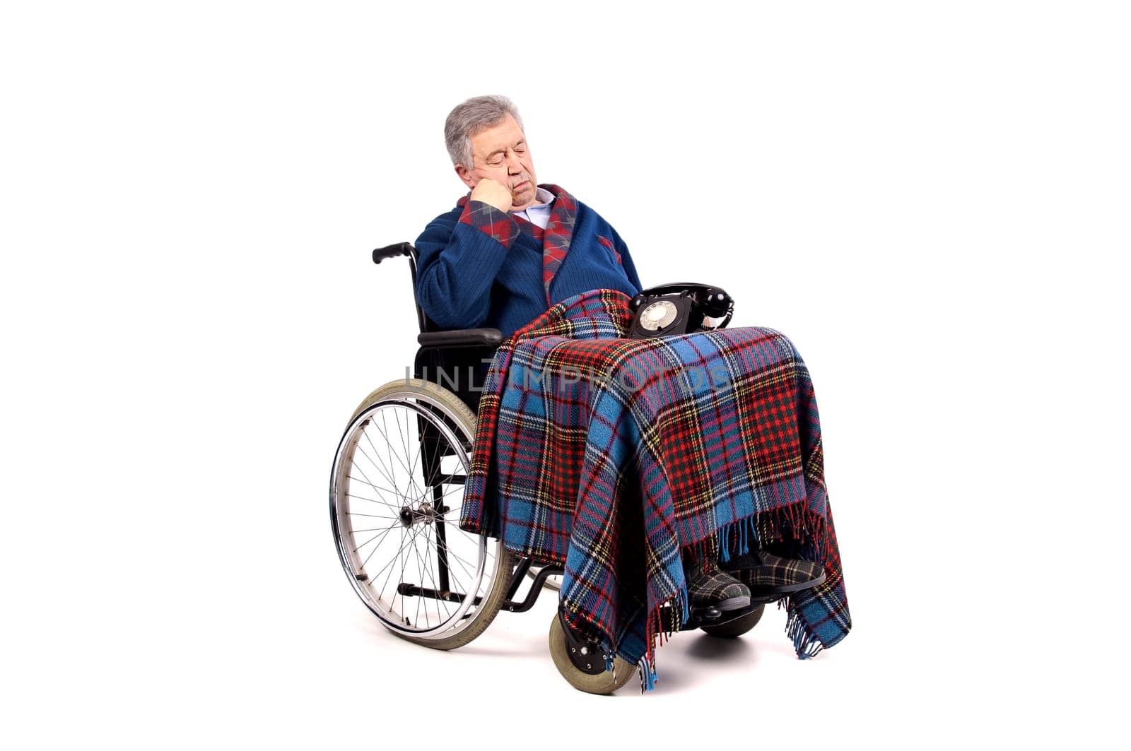 Lonely elderly in a wheelchairstaring at the phone