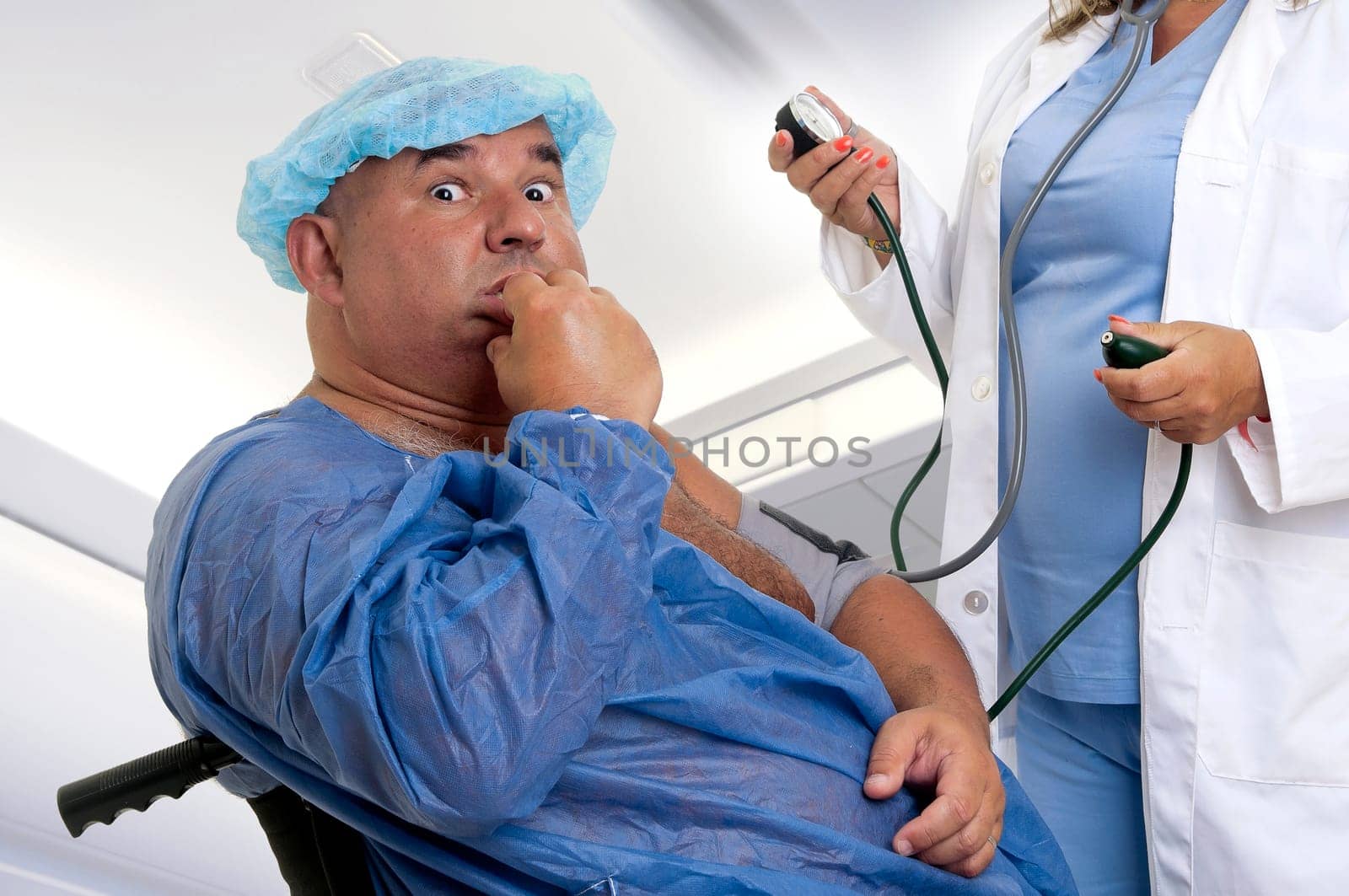 Large male patient in a wheelchair with doctor