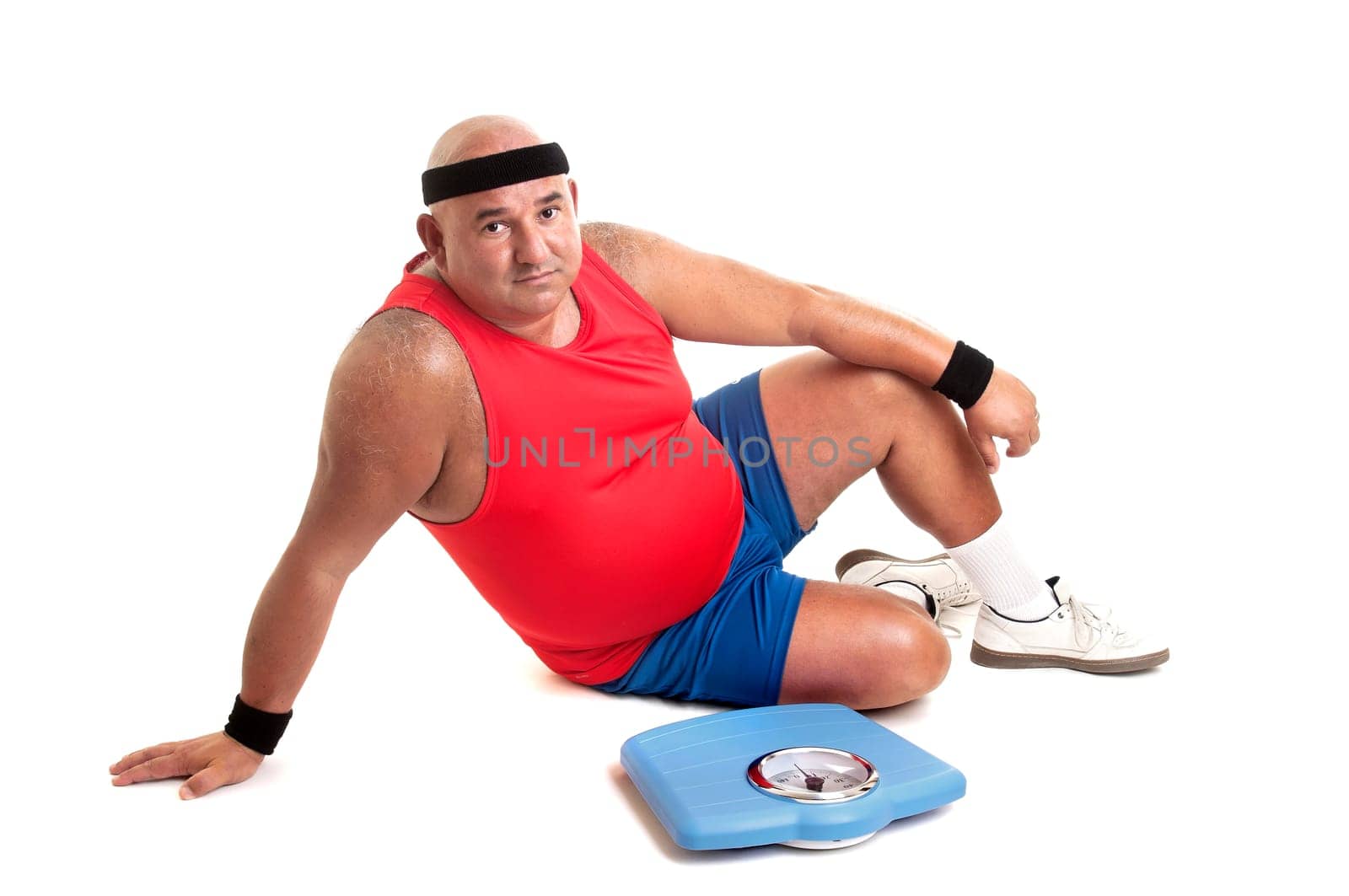 Large fitness man with weight scale isolated in white