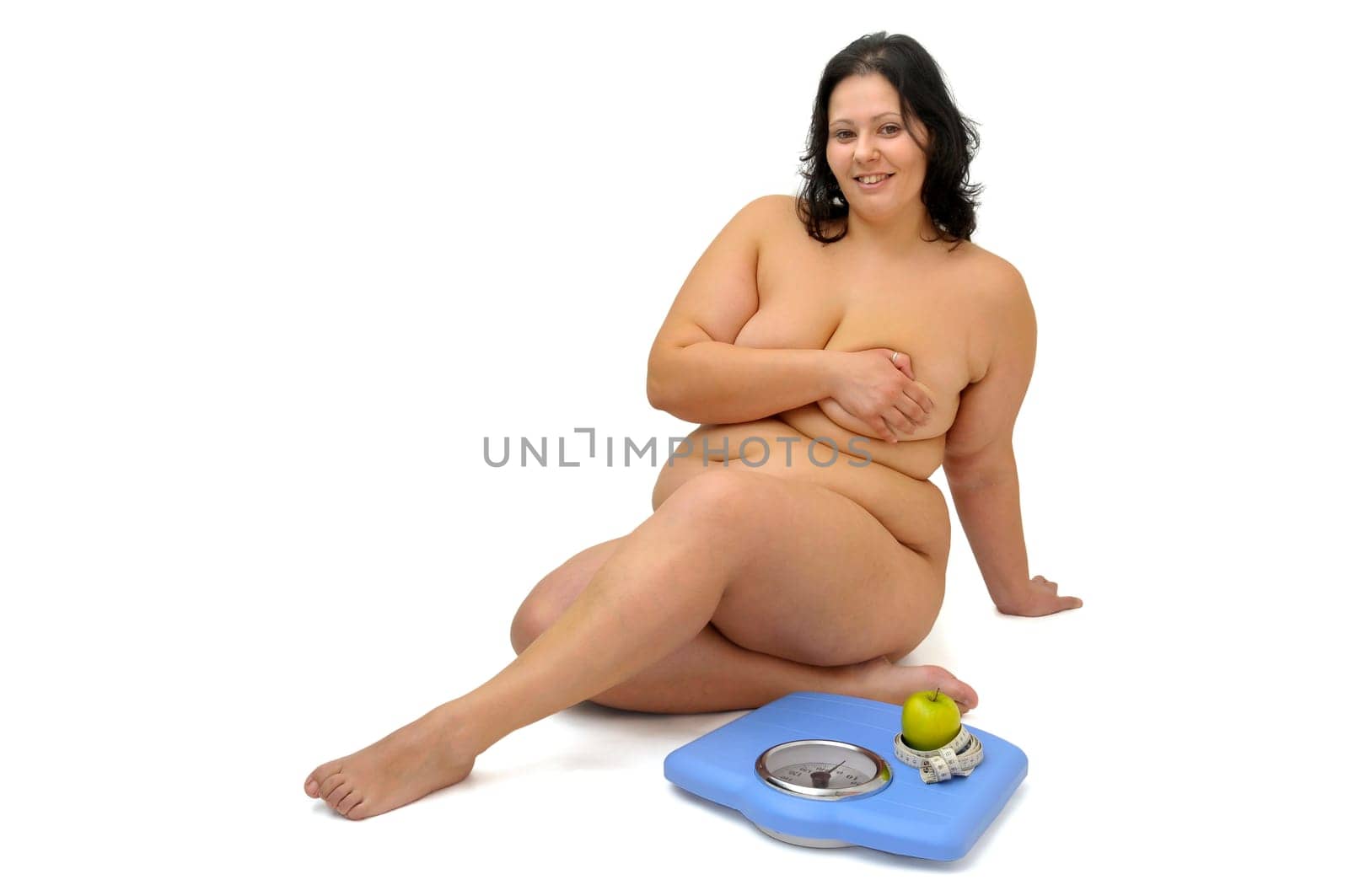 Beautiful large girl with weight scale isolated in white