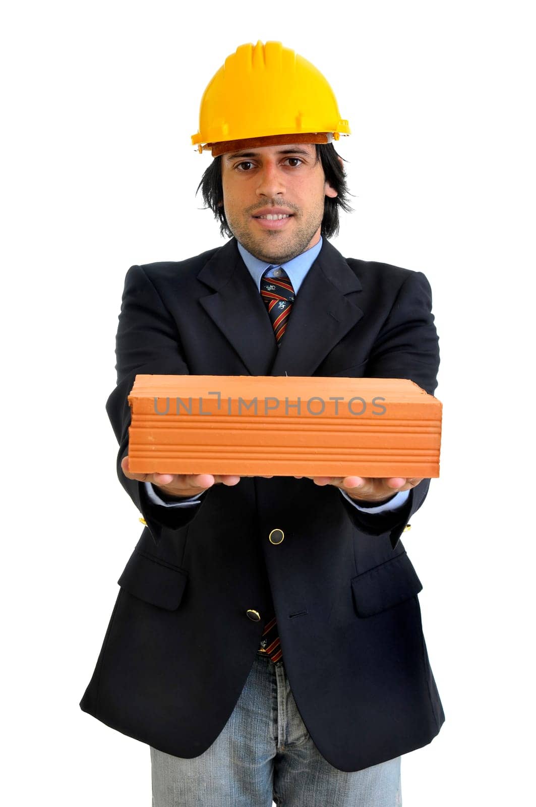 Young engineer with hat and brick isolated in white