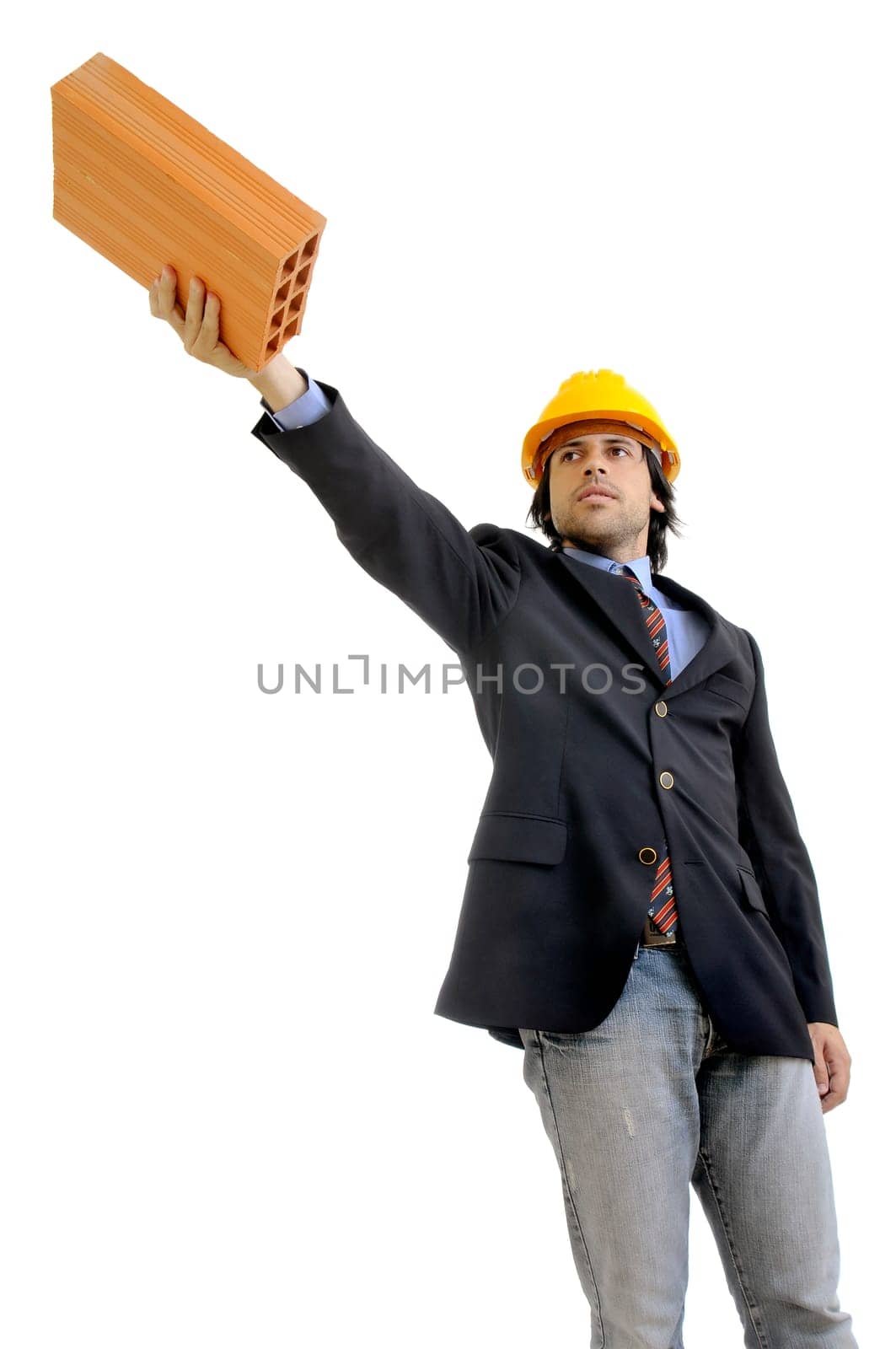 Young engineer with hat and brick isolated in white