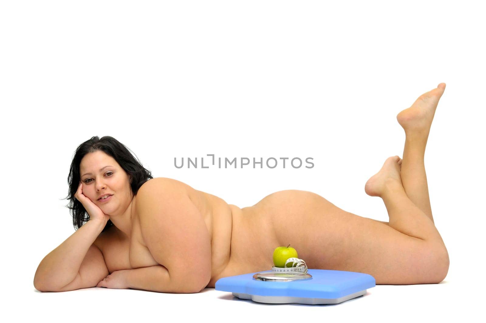 Beautiful nude large girl isolated in white with apple and weight scale