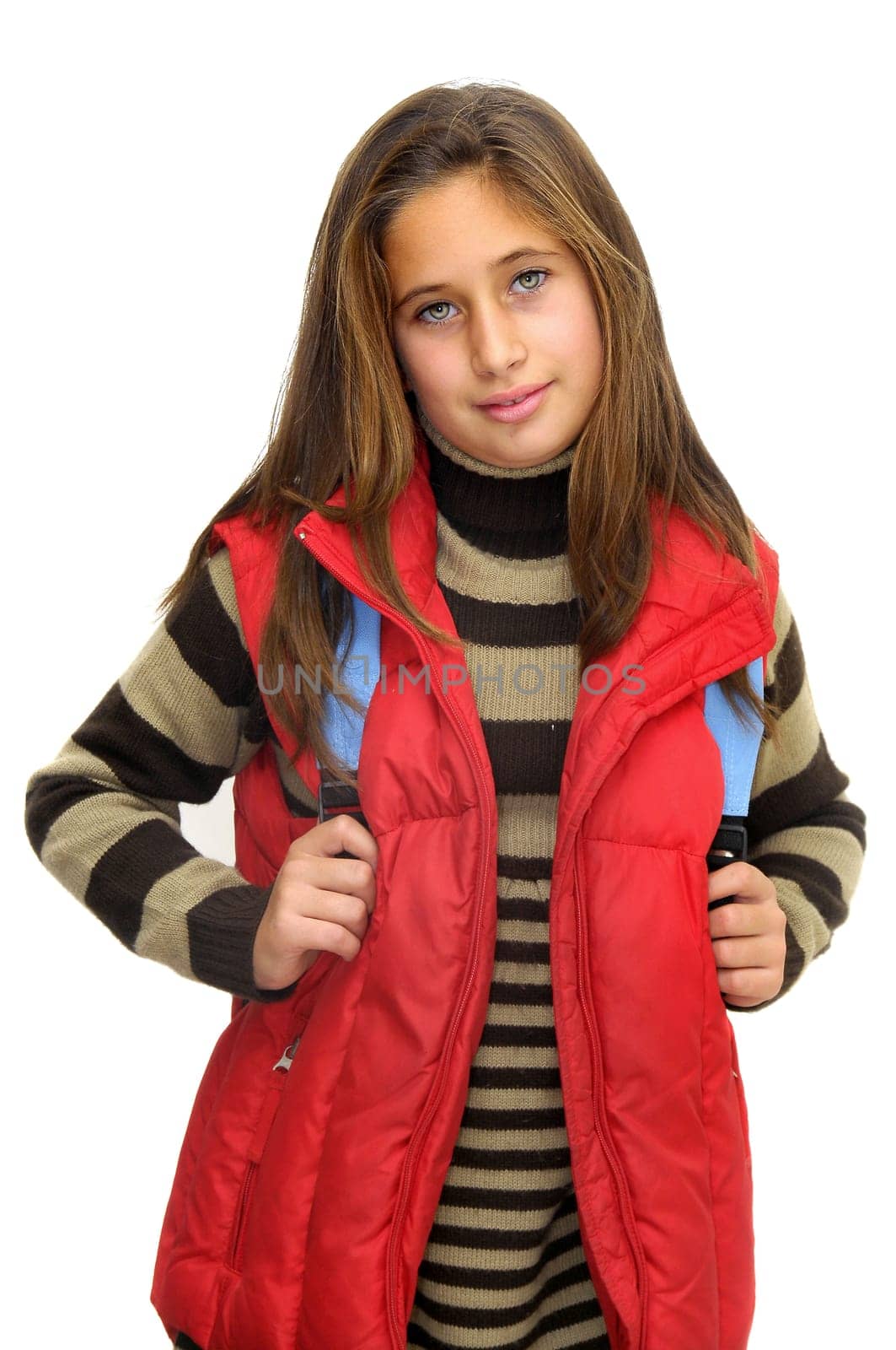 Beautiful young girl posing with backpack against a white background