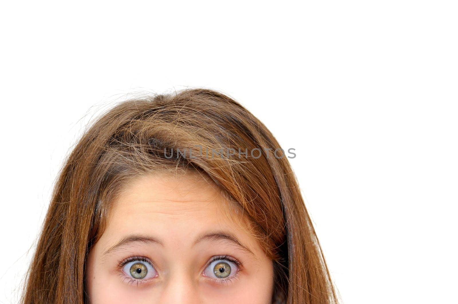 Beautiful young girl's green eyes isolated in white