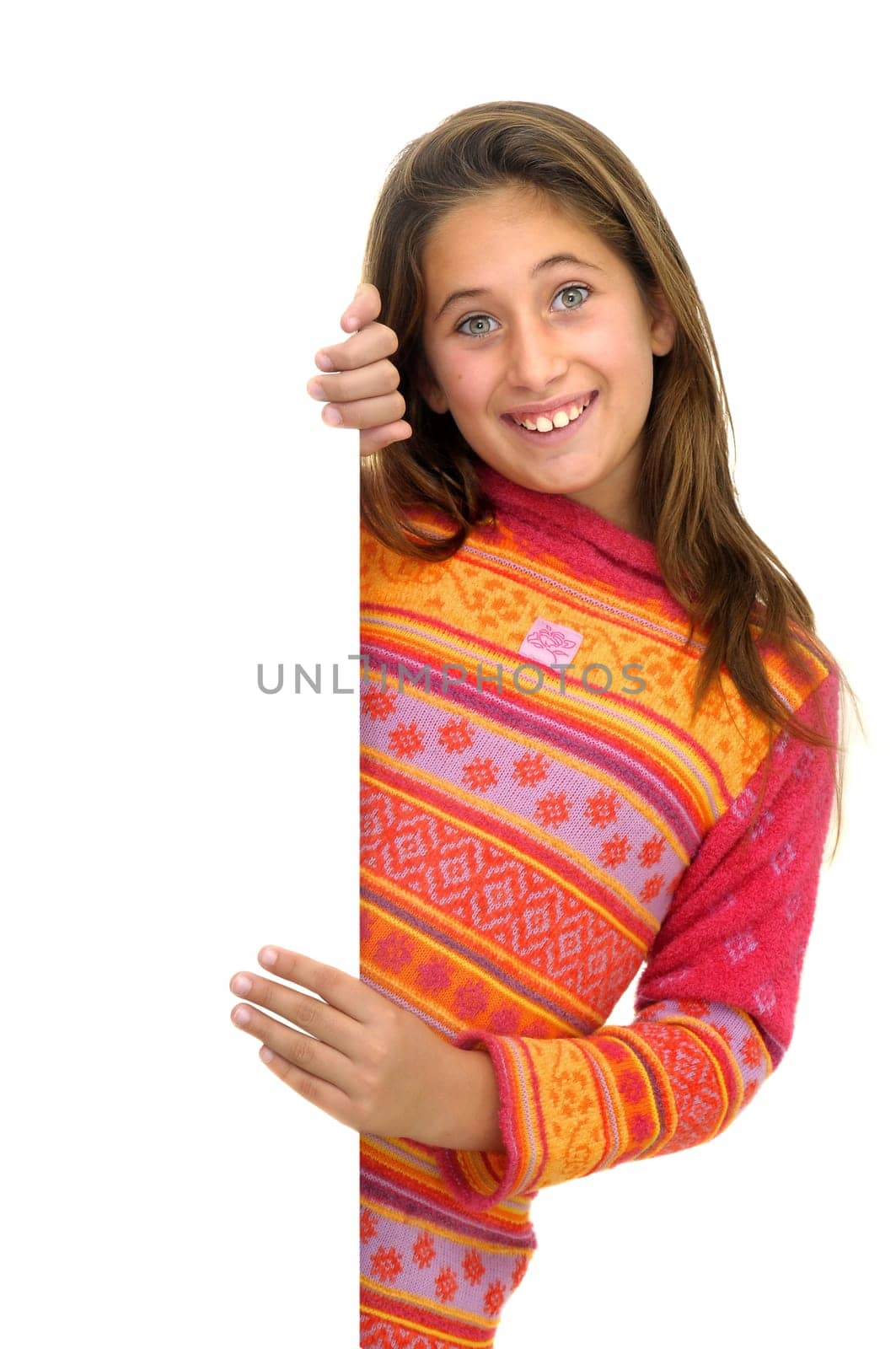 Beautiful young girl posing behind a white card isolated against a white background
