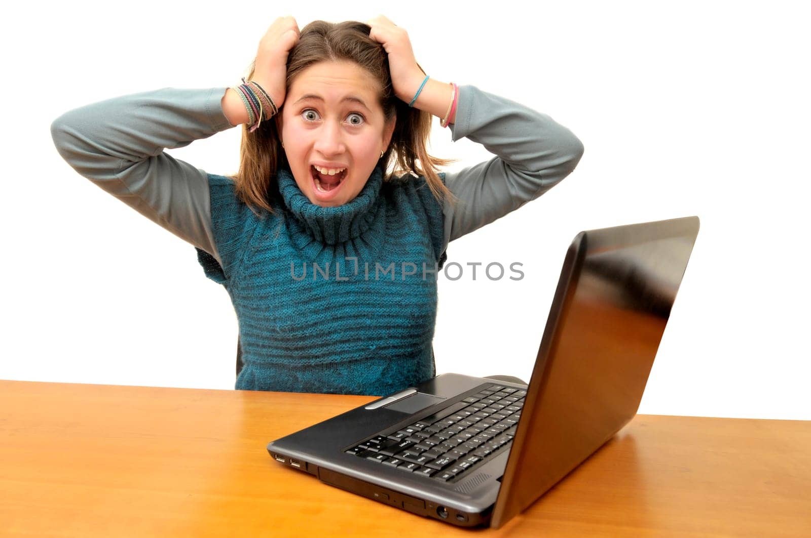 Stressed young girl in front of a laptop computer
