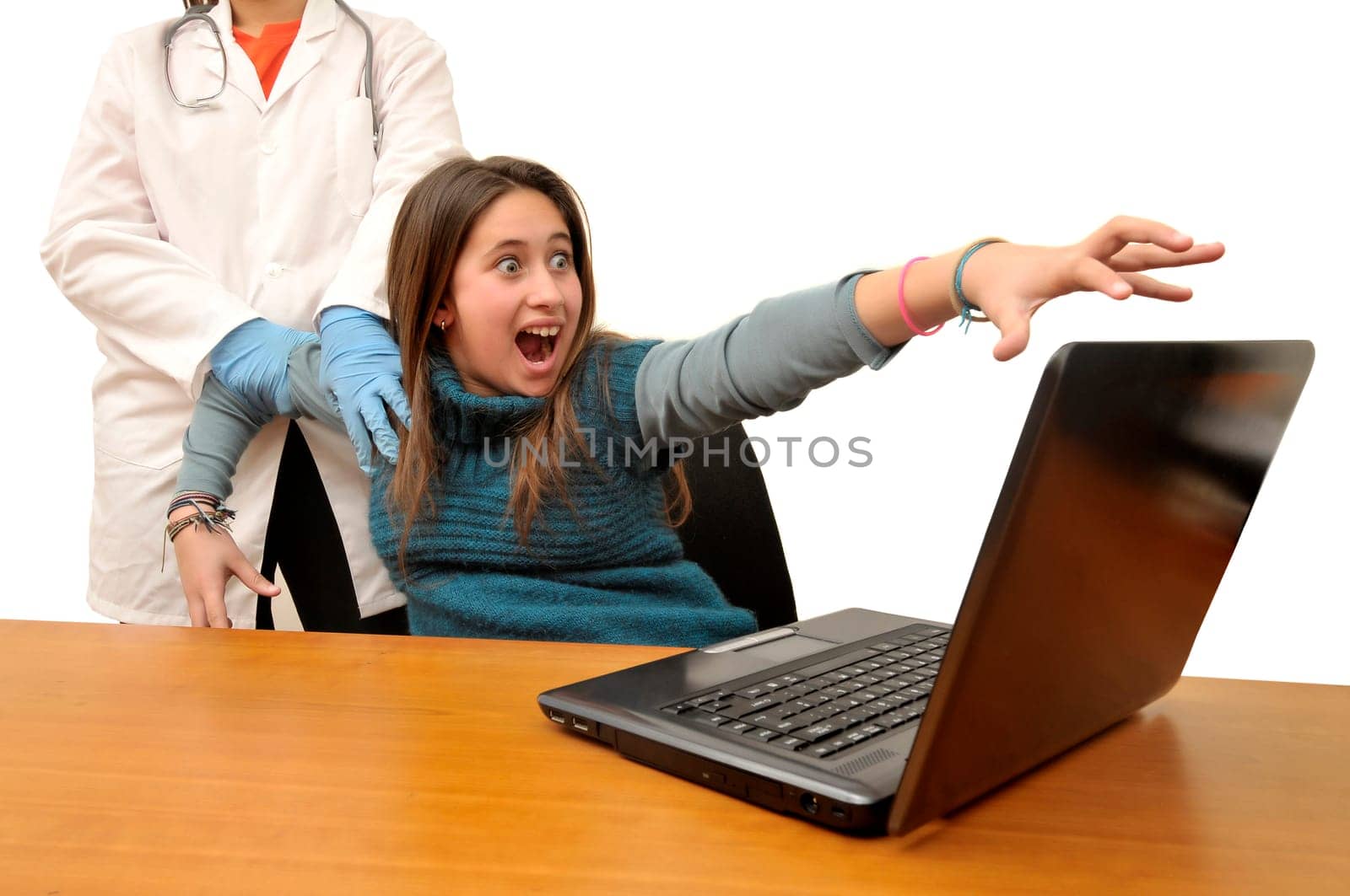 Stressed young girl being dragged by a doctor from her laptop computer