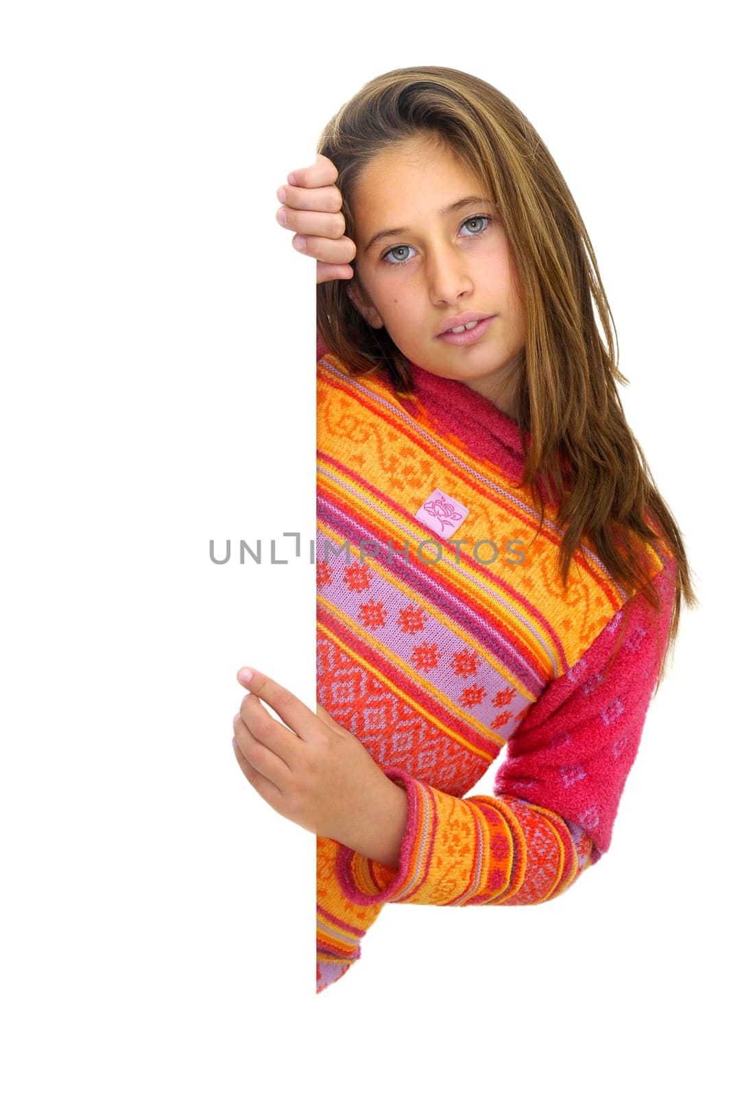 Beautiful young girl posing behind a white card isolated against a white background