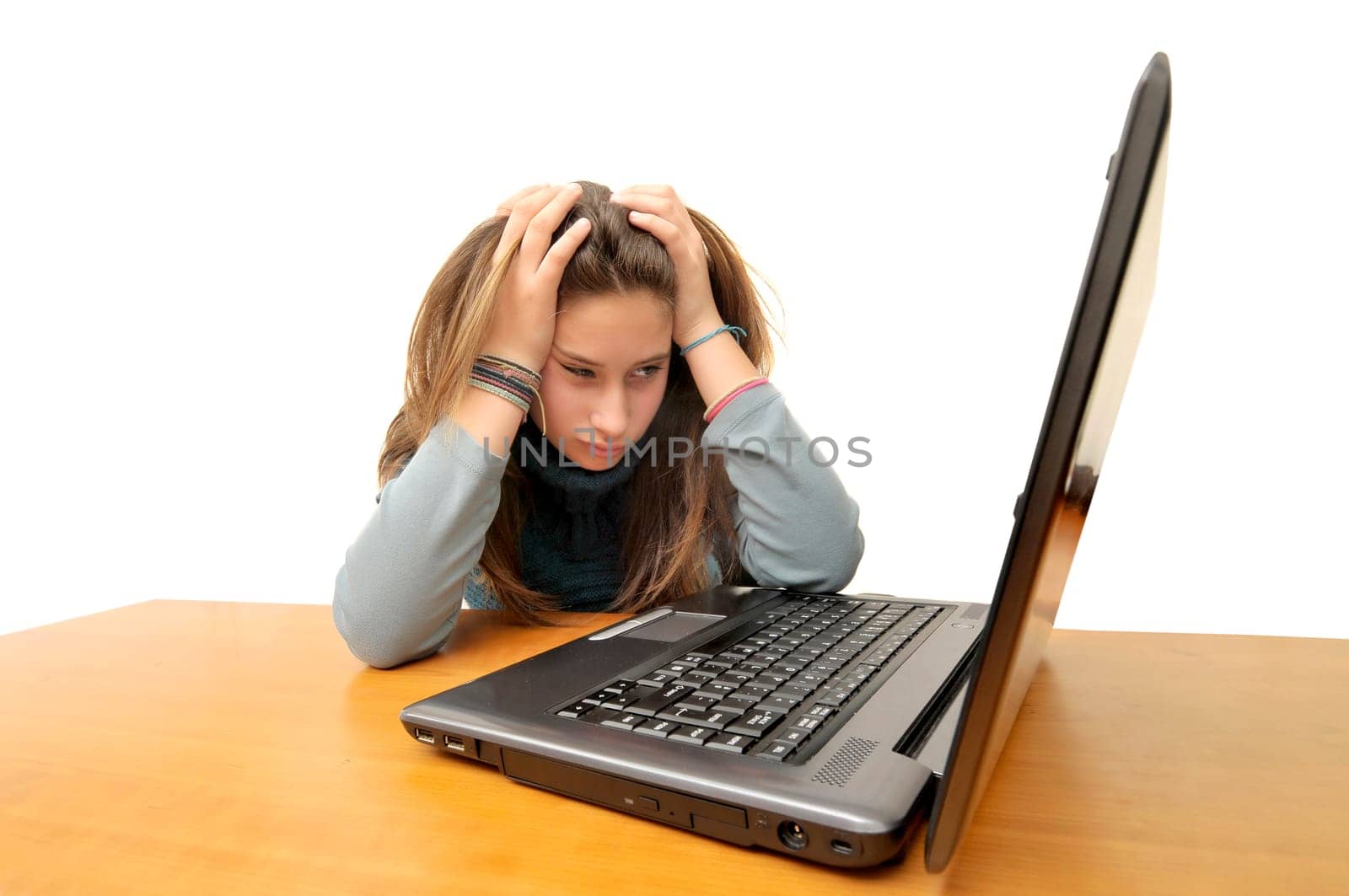 Stressed young girl in front of a laptop computer