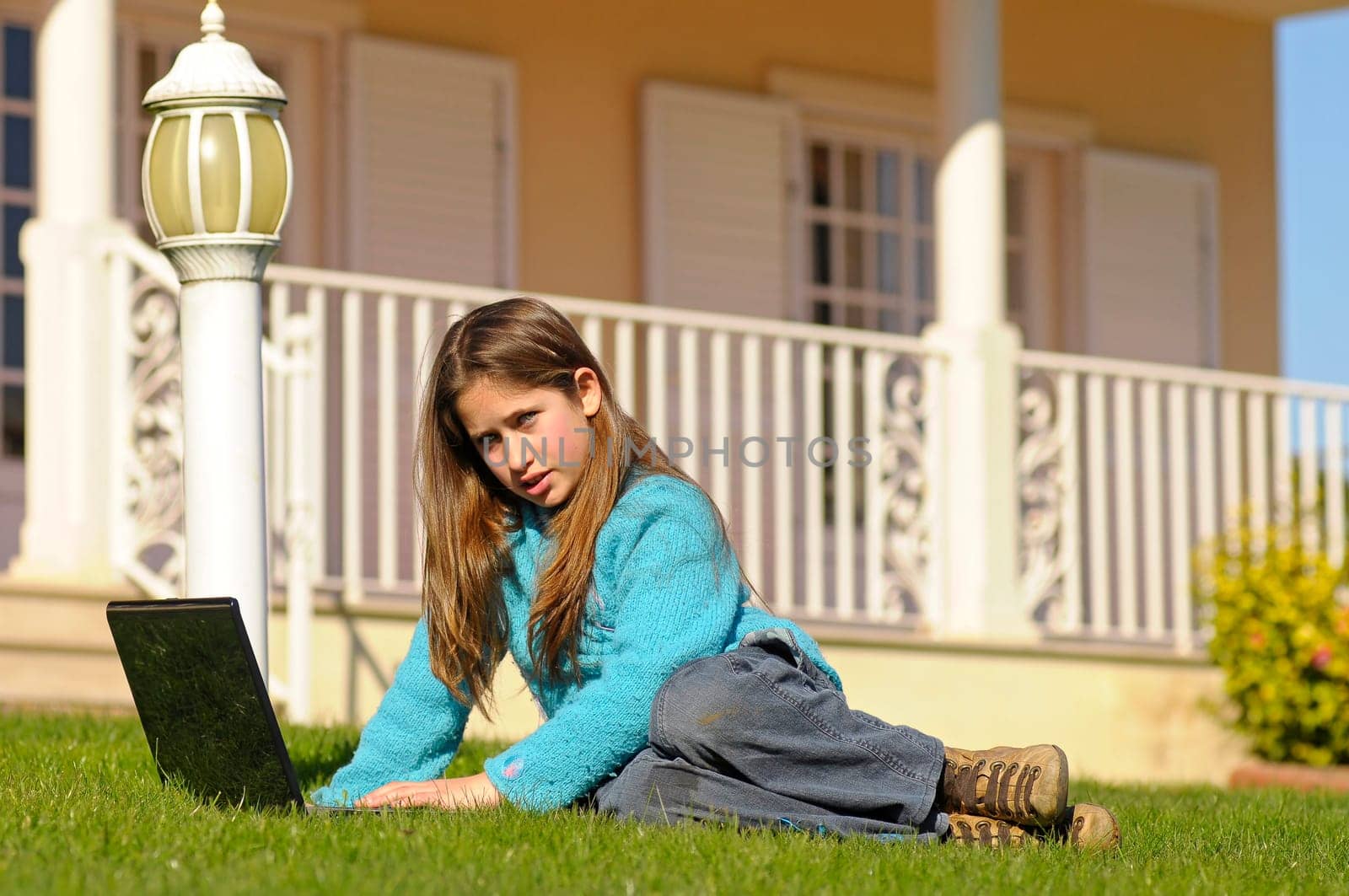Girl on the grass with laptop