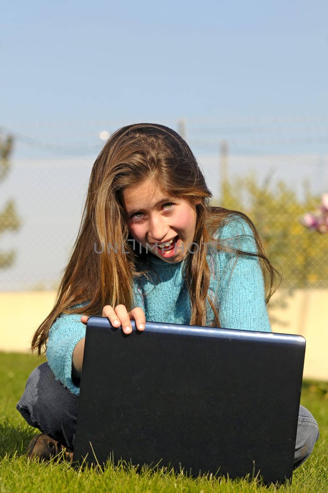 Girl on the grass with laptop